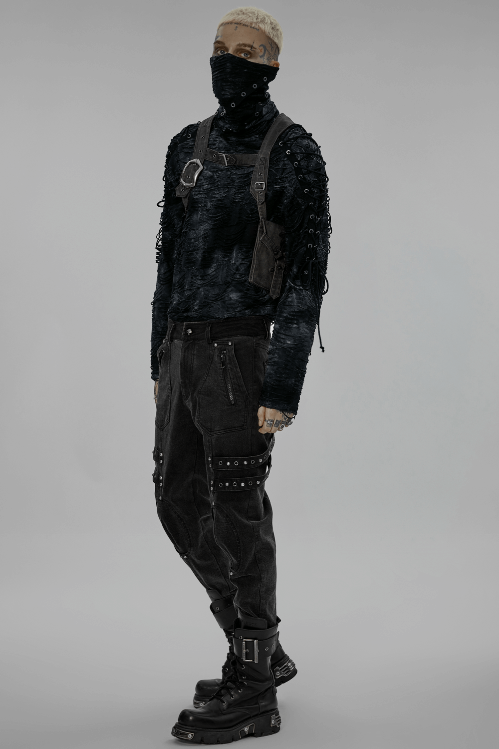 Model showcasing edgy post-apocalyptic outfit with black leather crossbody bag and combat boots, perfect for punk style.