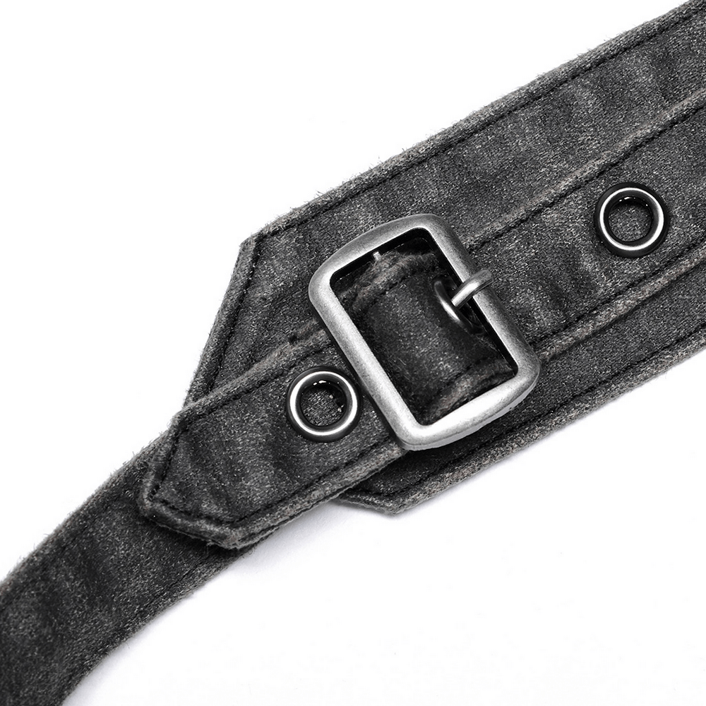 Close-up of a rugged adjustable buckle on a post-apocalyptic leather crossbody bag.