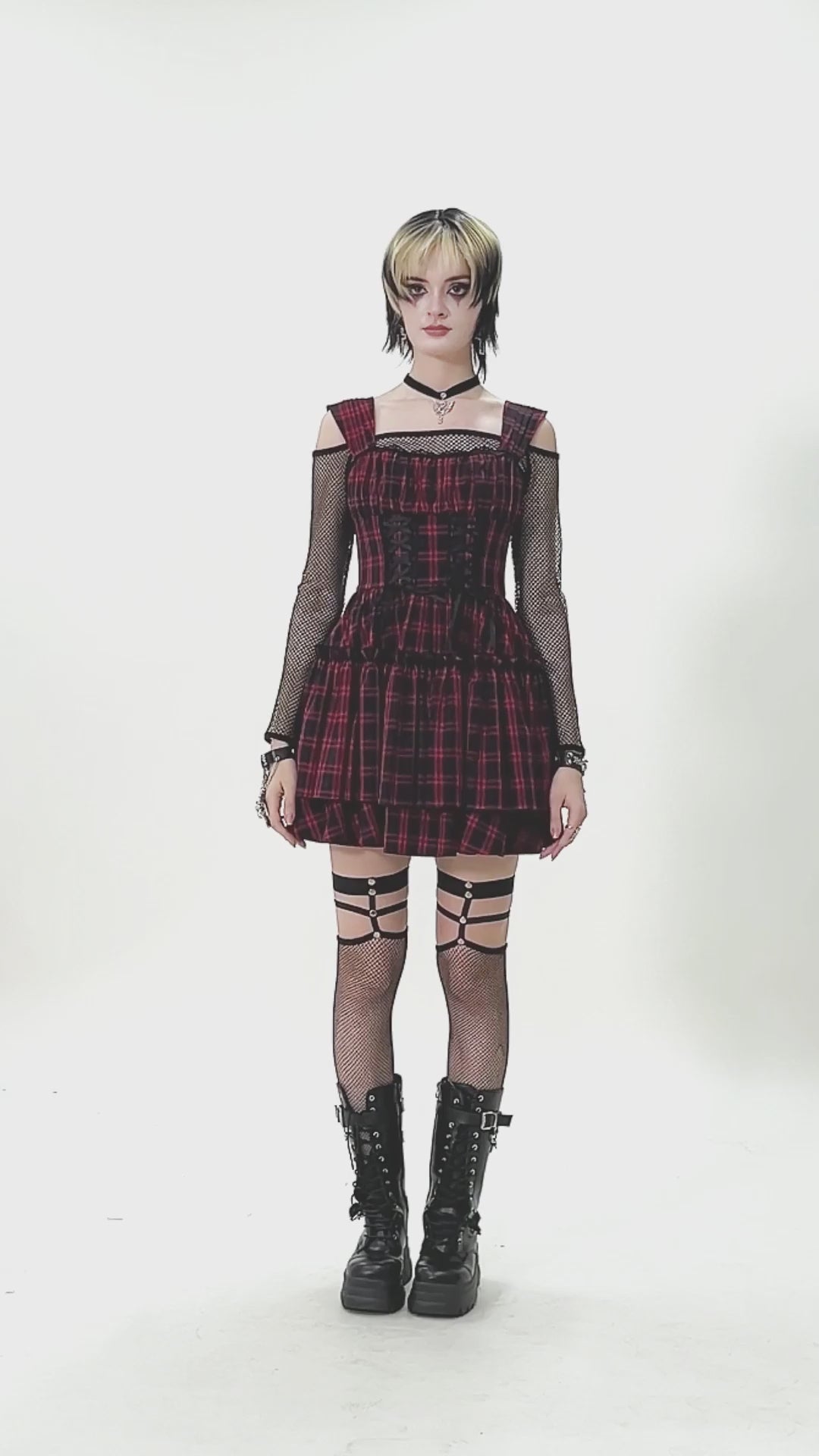 Gothic Plaid Dress with Lace-Up and Ruffled Skirt worn by model, showcasing edgy plaid design and stylish accessories.
