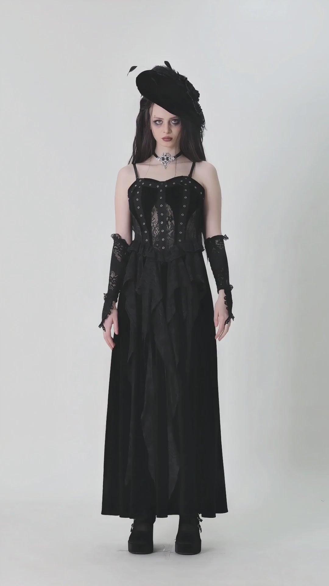 Dark romantic corset gown with lace and ruffled details, featuring adjustable straps and a flowing velvet skirt.