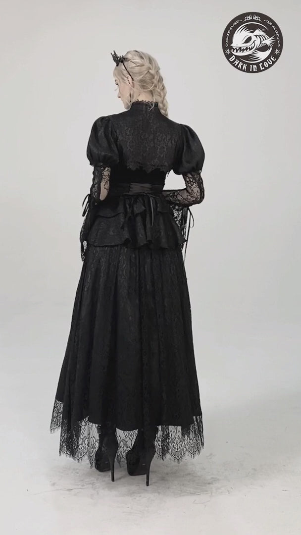 Victorian-inspired black lace skirt with ruffles, elegant satin ribbon, worn with a stylish top and heels.