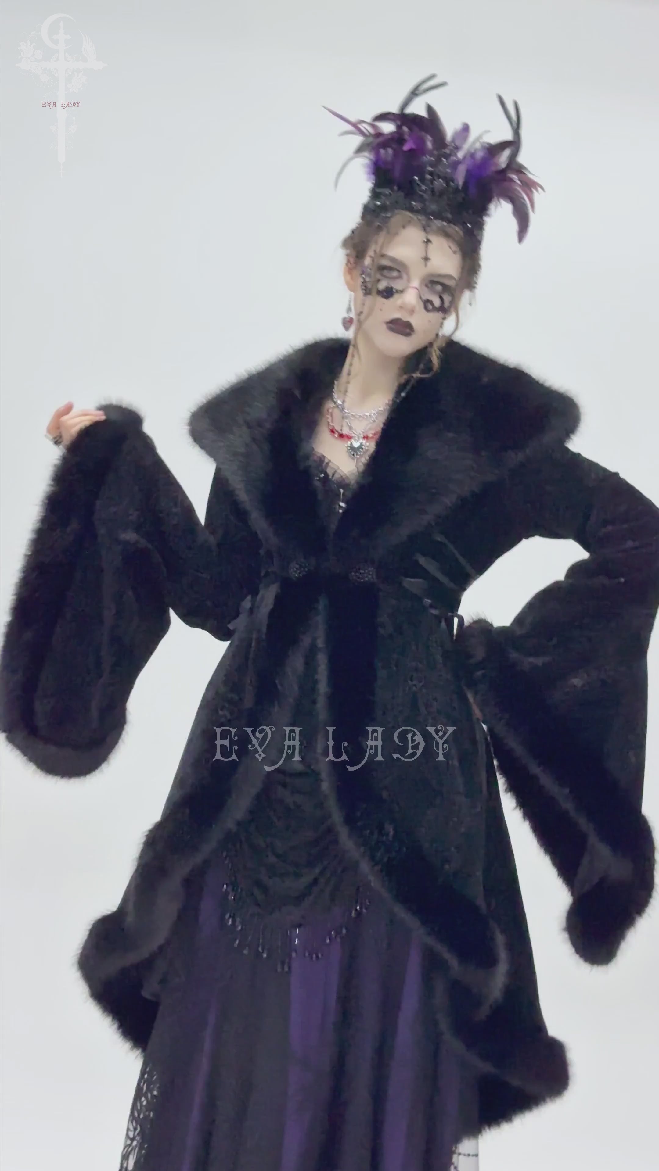 Woman in a black fur-trimmed coat with lace-up waist details, showcasing vintage Gothic elegance and dramatic flair.