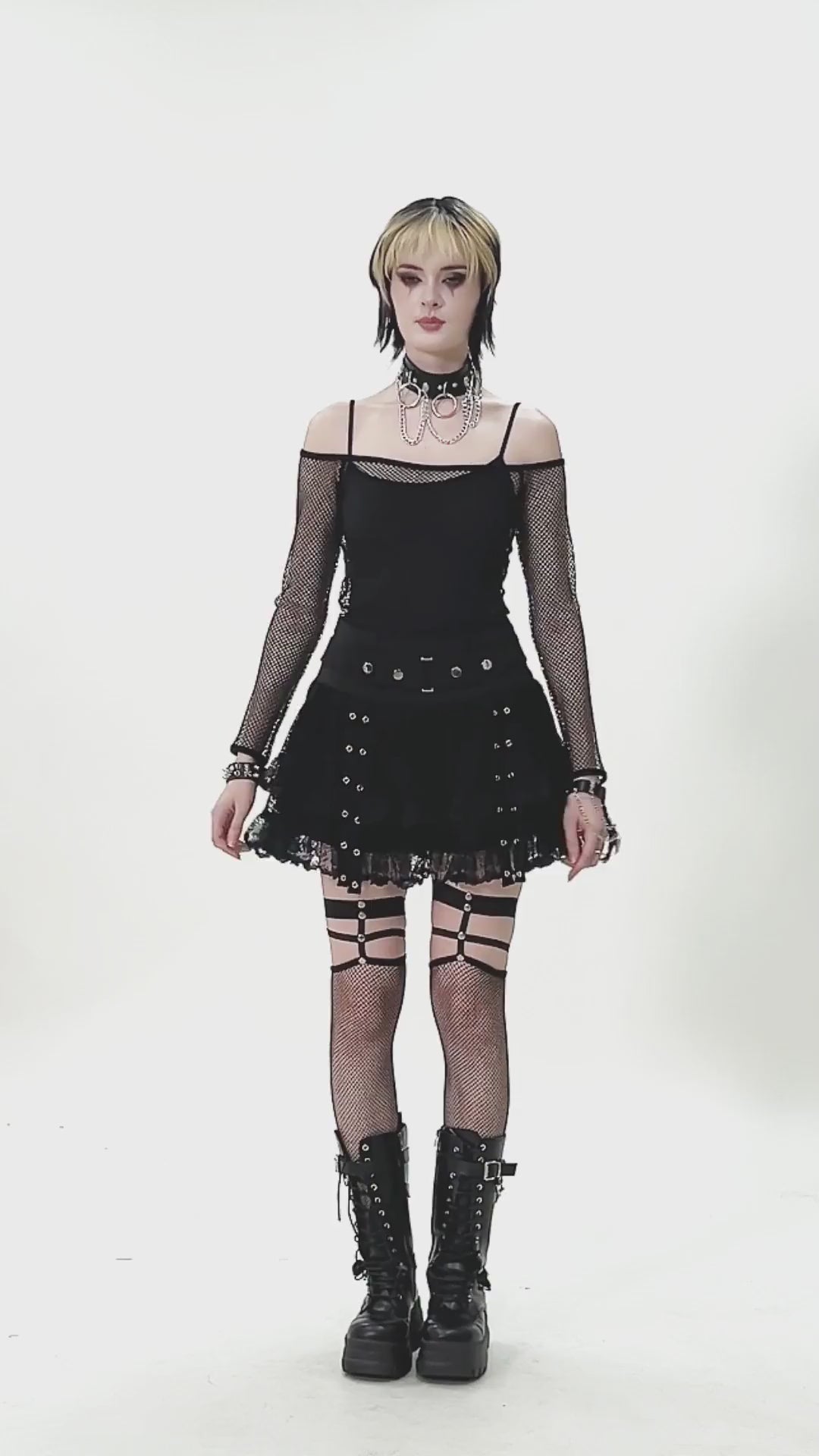 Black Lace Mini Skirt with Straps and Layered Ruffles styled with fishnet sleeves and chunky boots.
