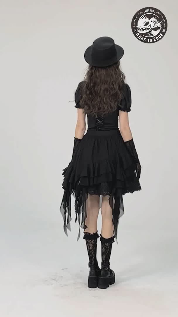 Back view of a model in a gothic asymmetric ruffle skirt, paired with a black hat and lace-up boots for a punk style.