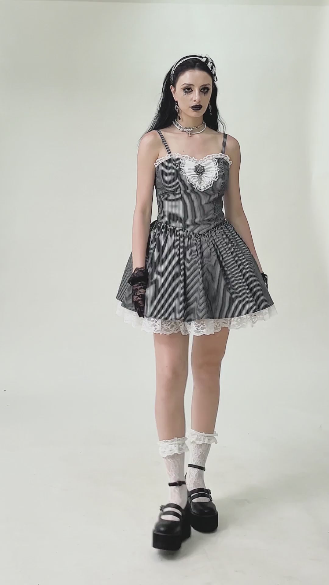 Vintage pinstripe gothic dress with lace trim, corset back, and playful flared skirt, styled with accessories.