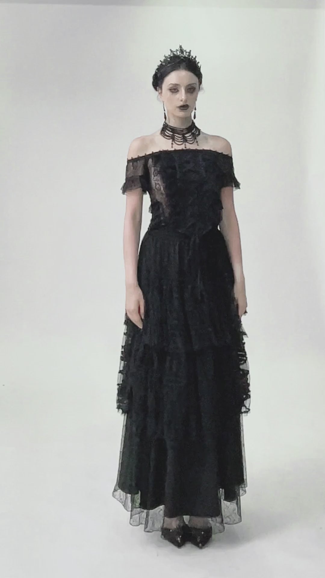 Off-shoulder lace-trimmed gothic top with ribbon details, stylishly paired with a dramatic black skirt.