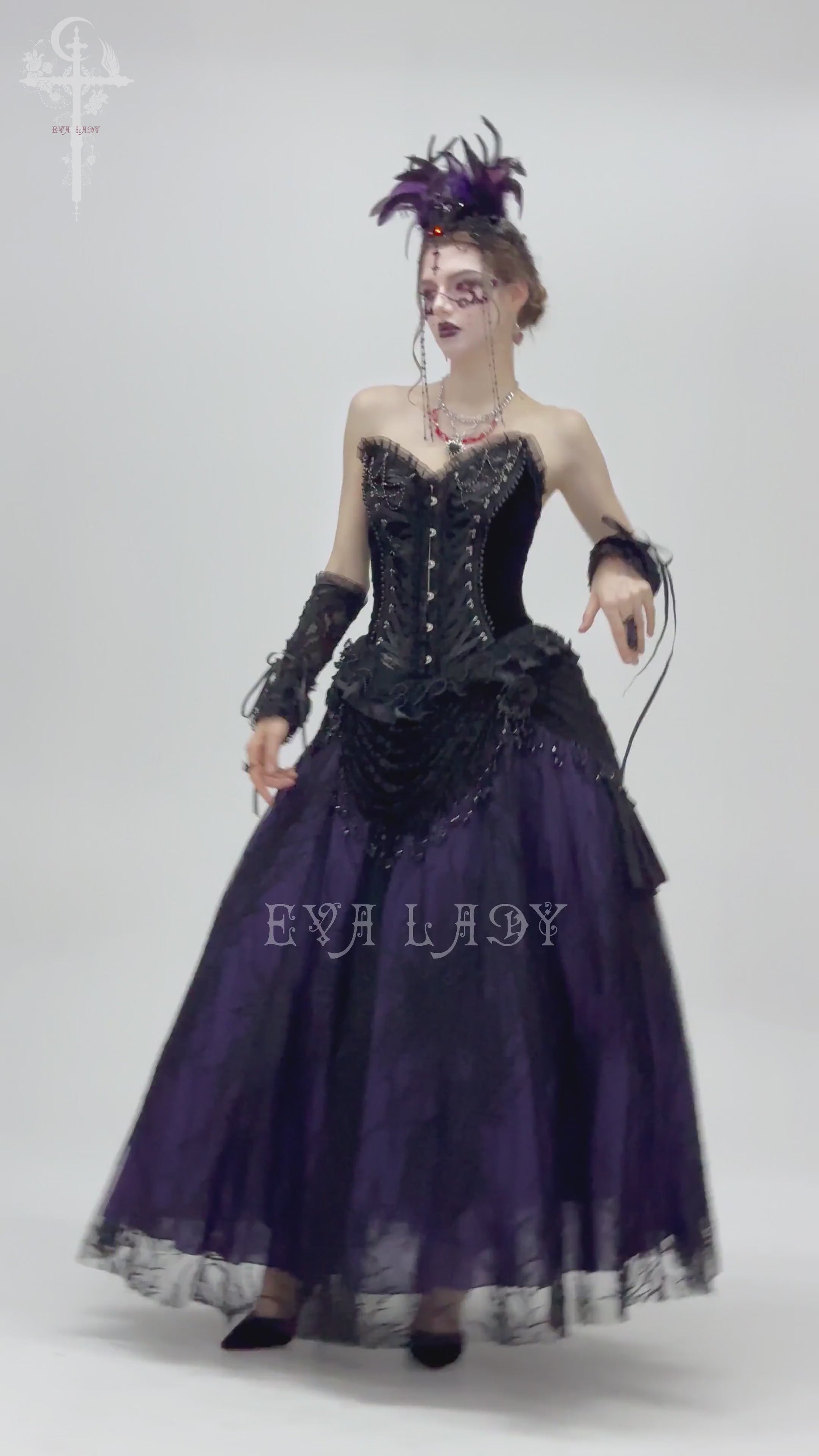 Gothic model in Victorian-style beaded skirt and corset, showcasing black and purple lace with elegant draping.