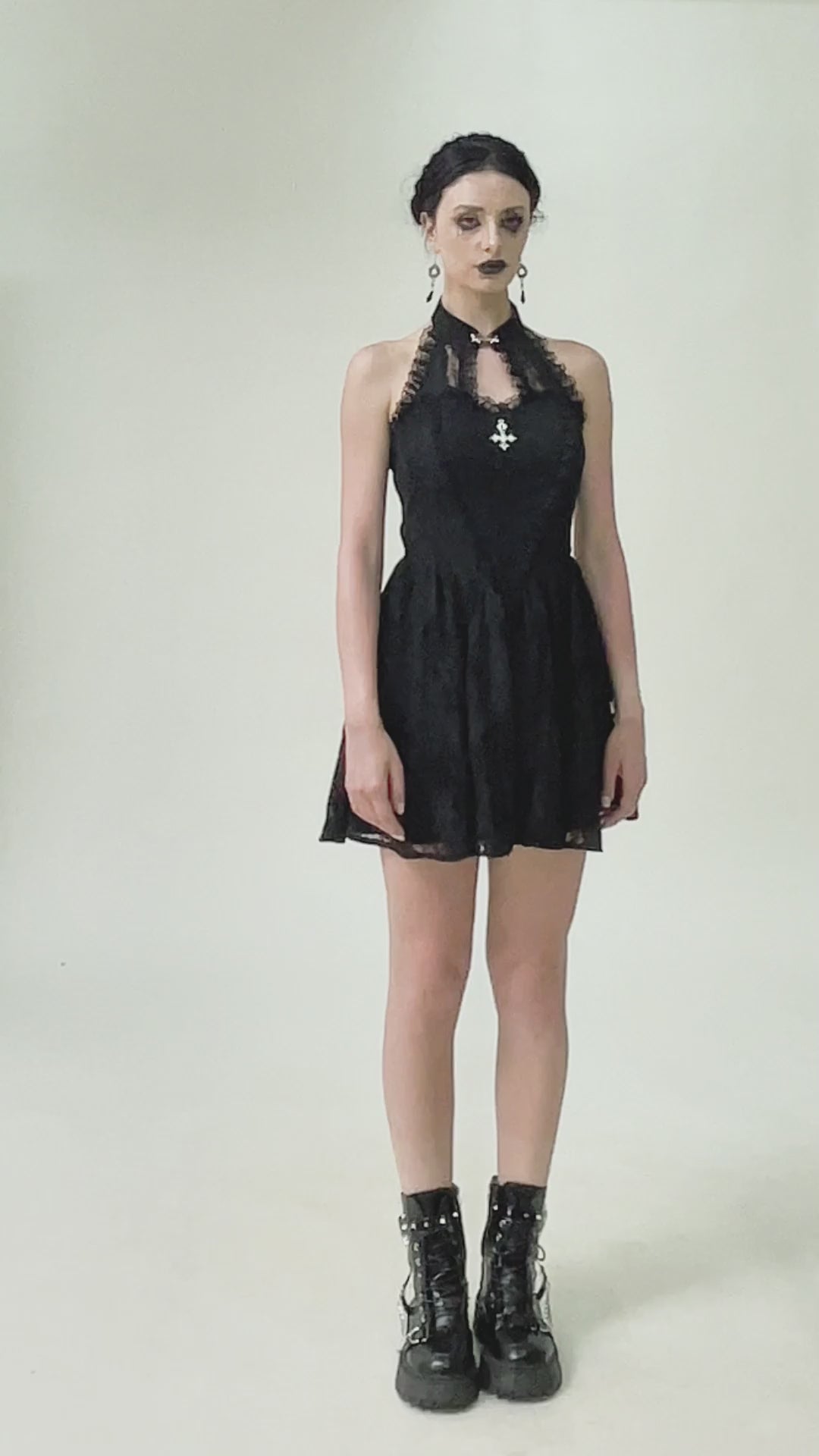 Model wearing a Gothic Lace Halter Dress with keyhole neckline and lace trim, paired with chunky boots for an edgy look.