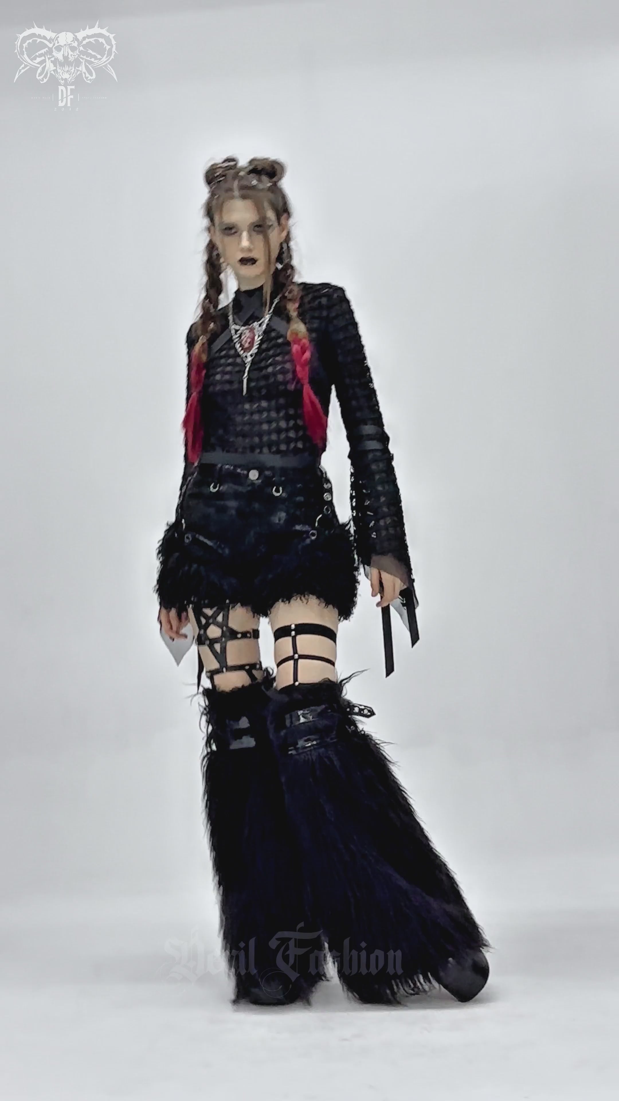 Stylish goth model wearing black faux leather shorts with fur trim and edgy accessories, showcasing alternative fashion.