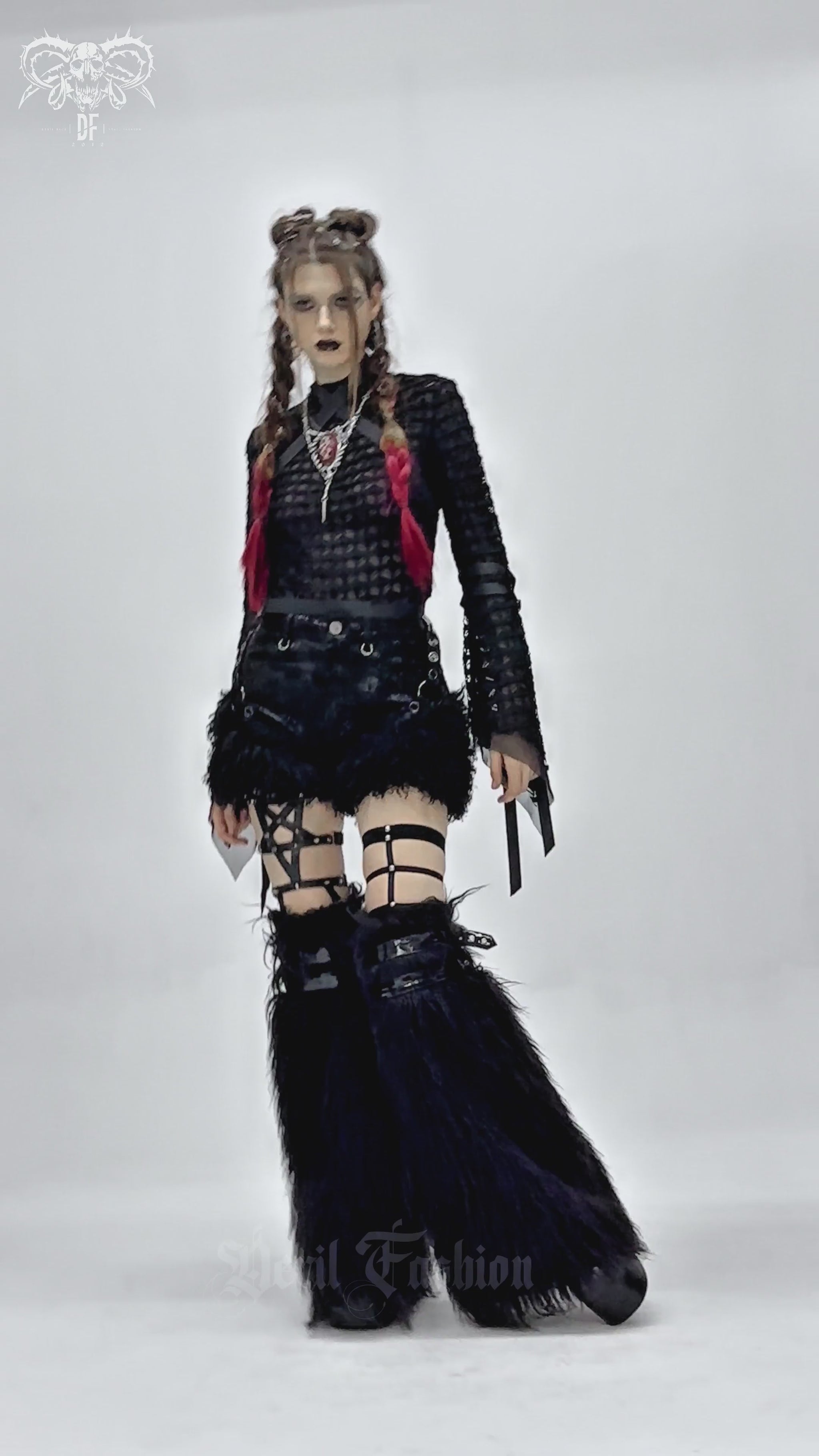 Stylish goth model wearing black faux leather shorts with fur trim and edgy accessories, showcasing alternative fashion.