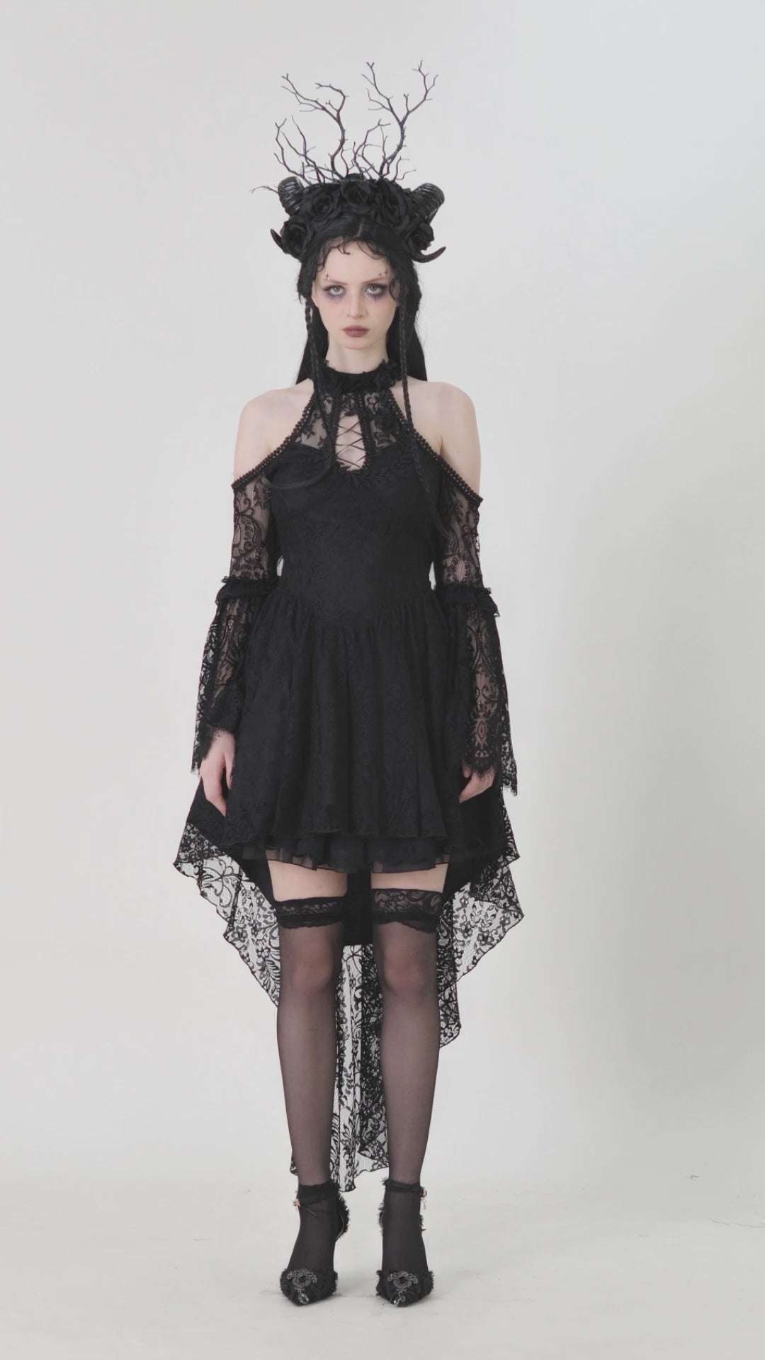 Black Gothic lace cutout dress with heart detail, ruffles, and open shoulders, featuring a dramatic high-low hemline.