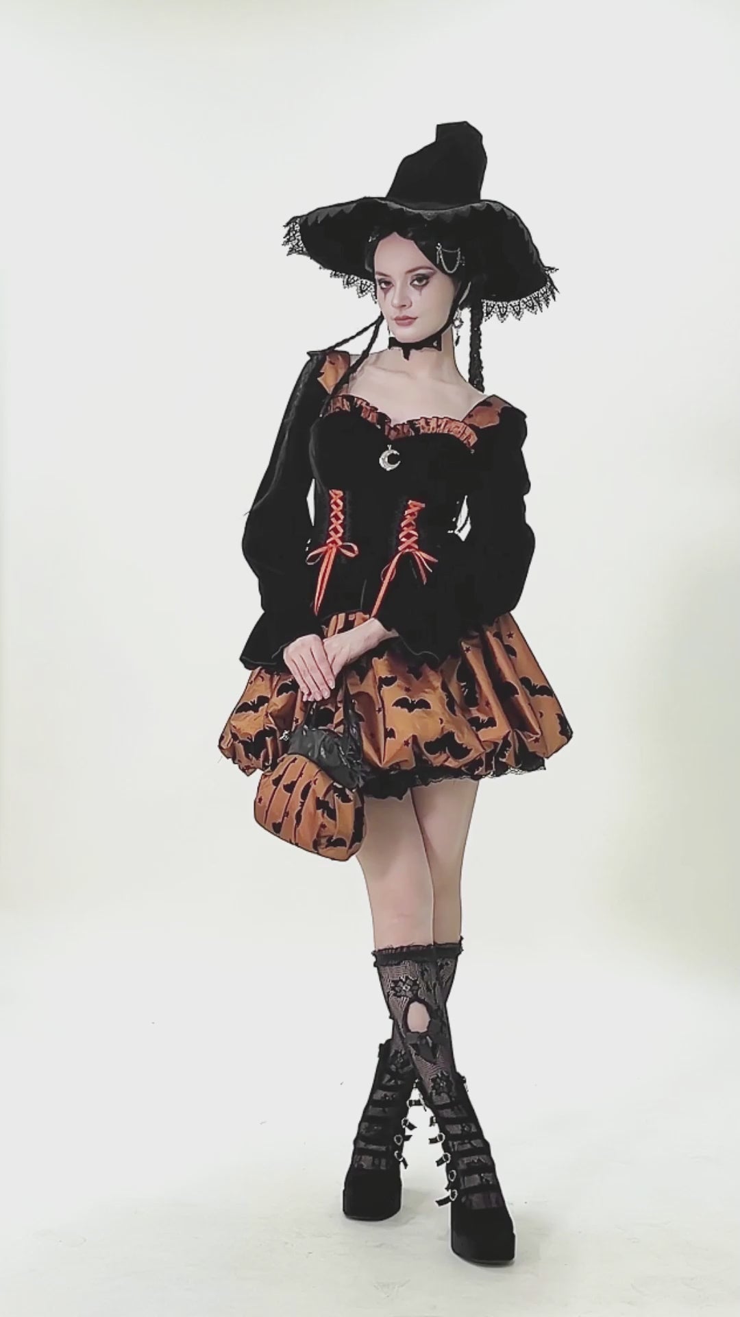 Gothic Pleated Bat and Star Print Handbag with Bat Zipper worn by a model in a stunning witch outfit.