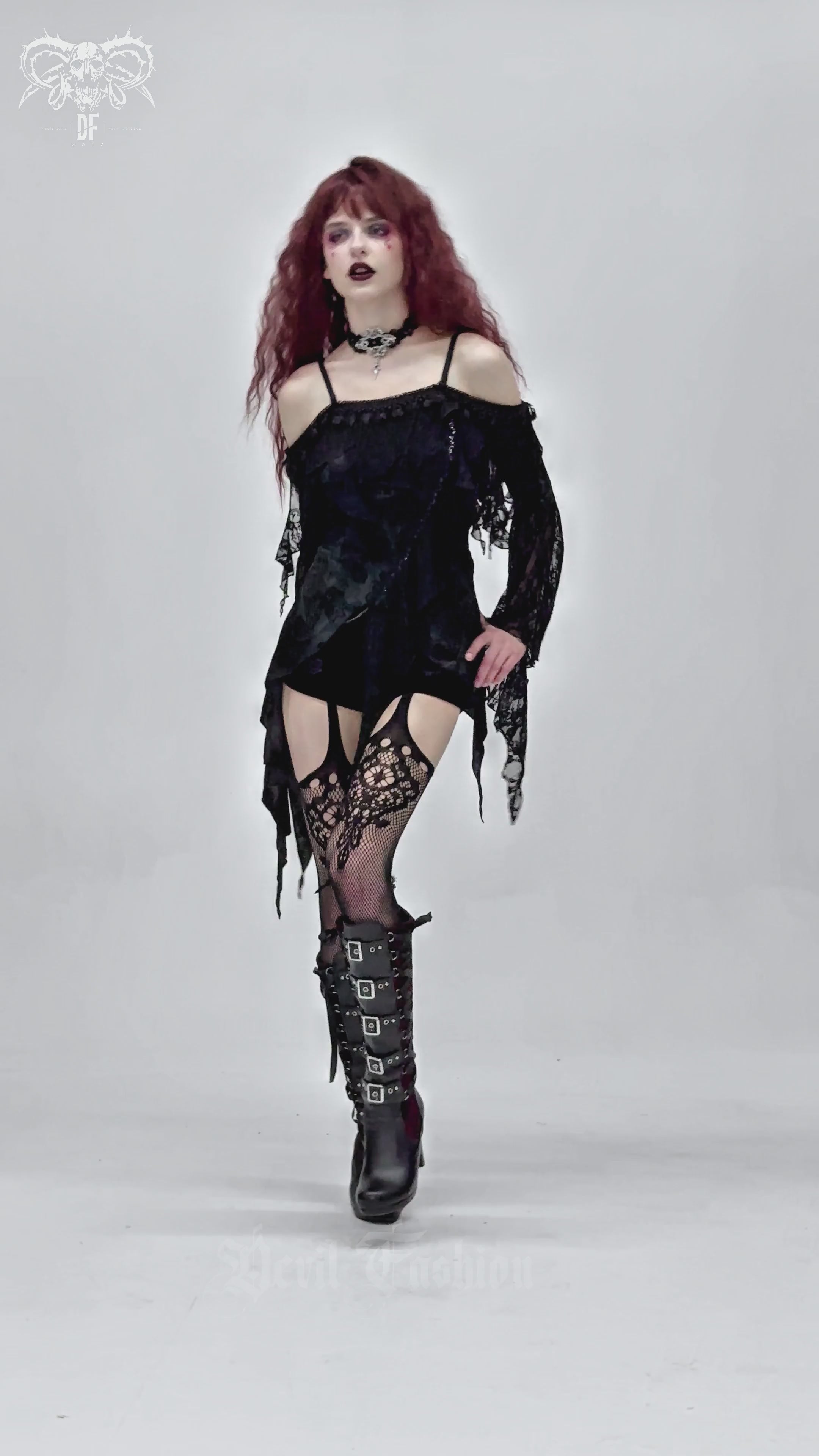 Gothic black lace off-shoulder top with flared sleeves, paired with edgy accessories for a dramatic look.