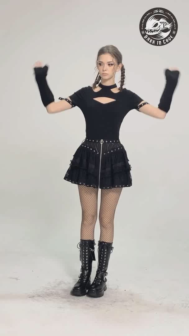 Gothic fashion model wearing a black lace ruffled skirt with adjustable lacing, paired with fishnet tights and combat boots.