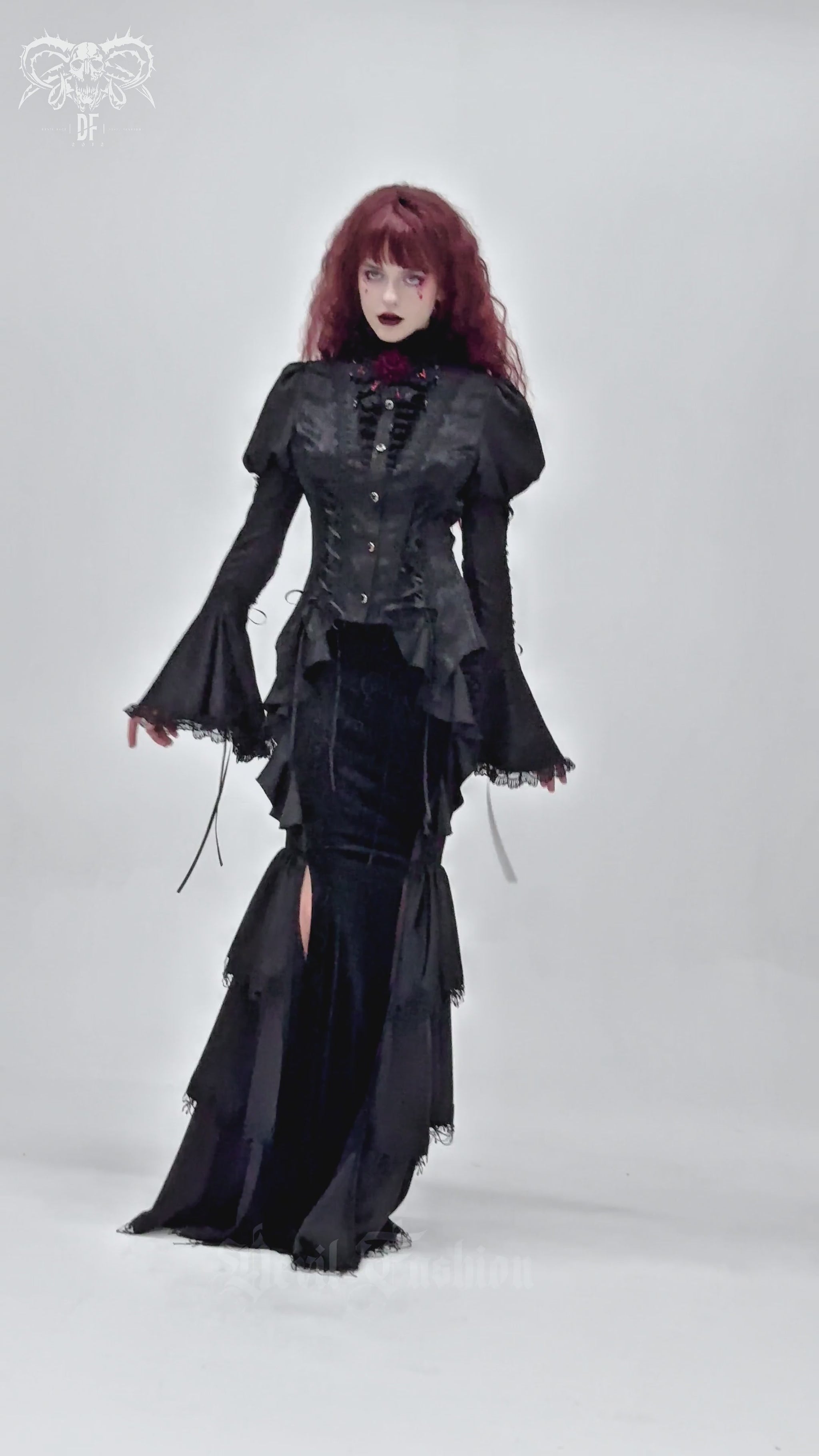 Victorian Gothic blouse with bell sleeves worn by a model, showcasing a lace-up design and ruffled collar.