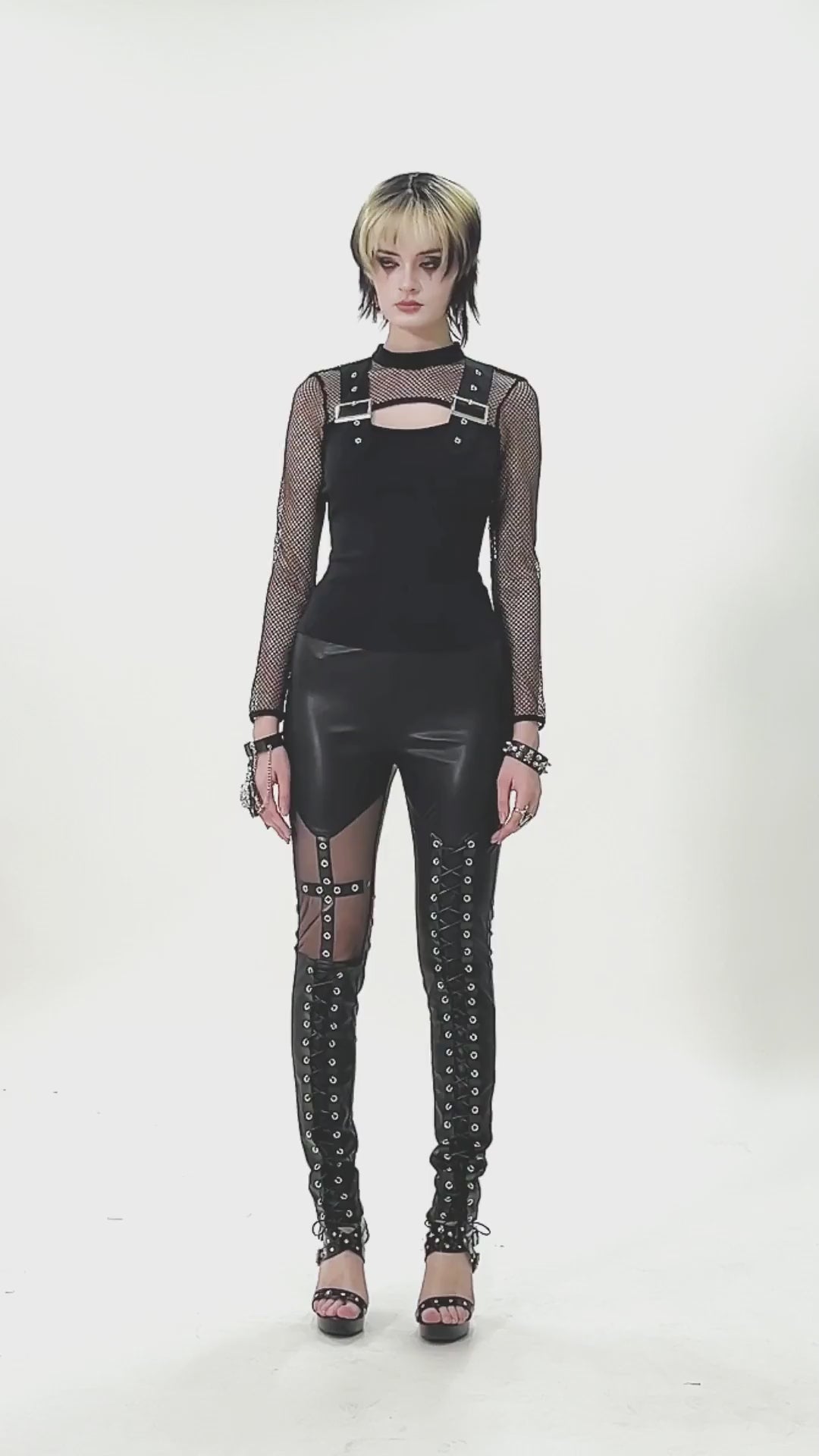 Punk Rock Black Fishnet Sleeved Top with Cutout and Straps styled with edgy leather pants.