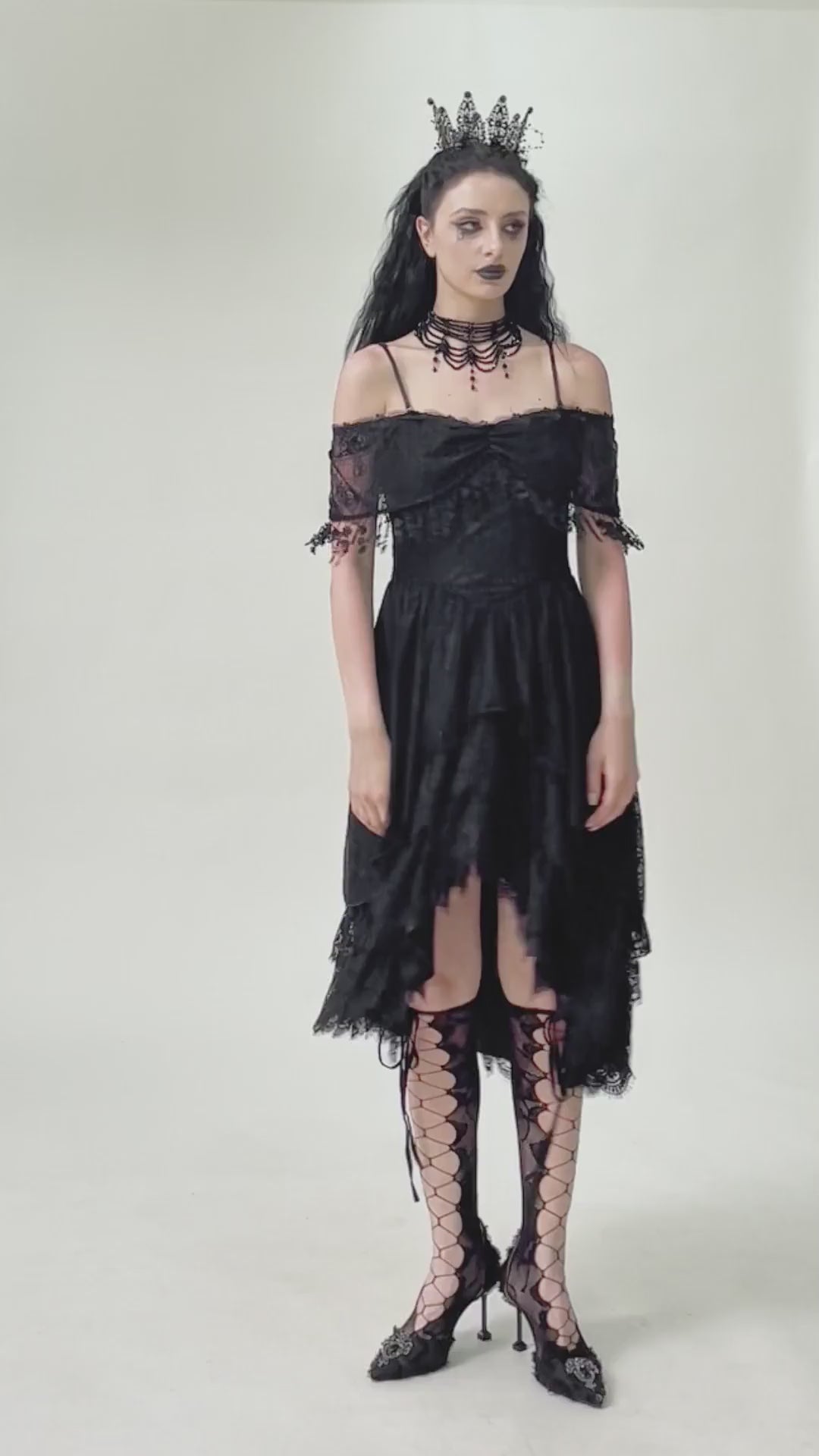 Chic Lace Off-Shoulder Dress with Corset and Ruffle Details worn by a model, featuring black lace, ruffles, and corset lacing.
