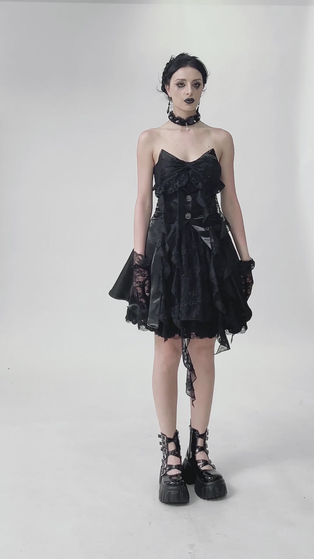 Gothic Lace and Satin Corset Mini Dress with Ruffle Details showcasing a model in a dark vintage-inspired outfit.