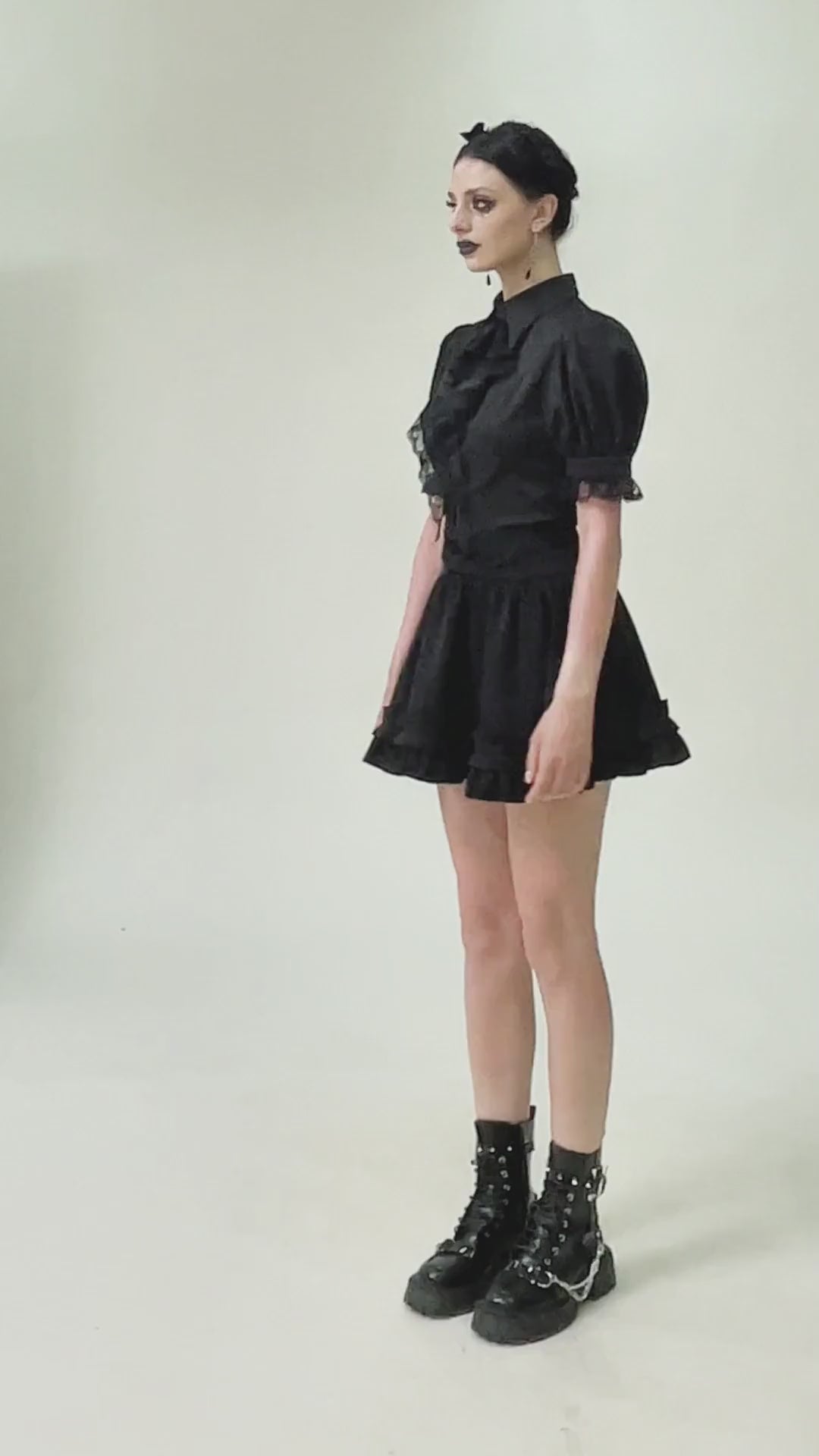 Goth ruffle lace blouse with puff sleeves, black satin finish and dramatic hemline, perfect for gothic fashion lovers.