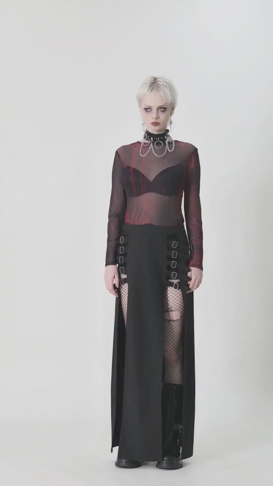 Edgy women's long-sleeved sheer mesh top in black and red, styled for a bold grunge look with a dramatic black skirt.