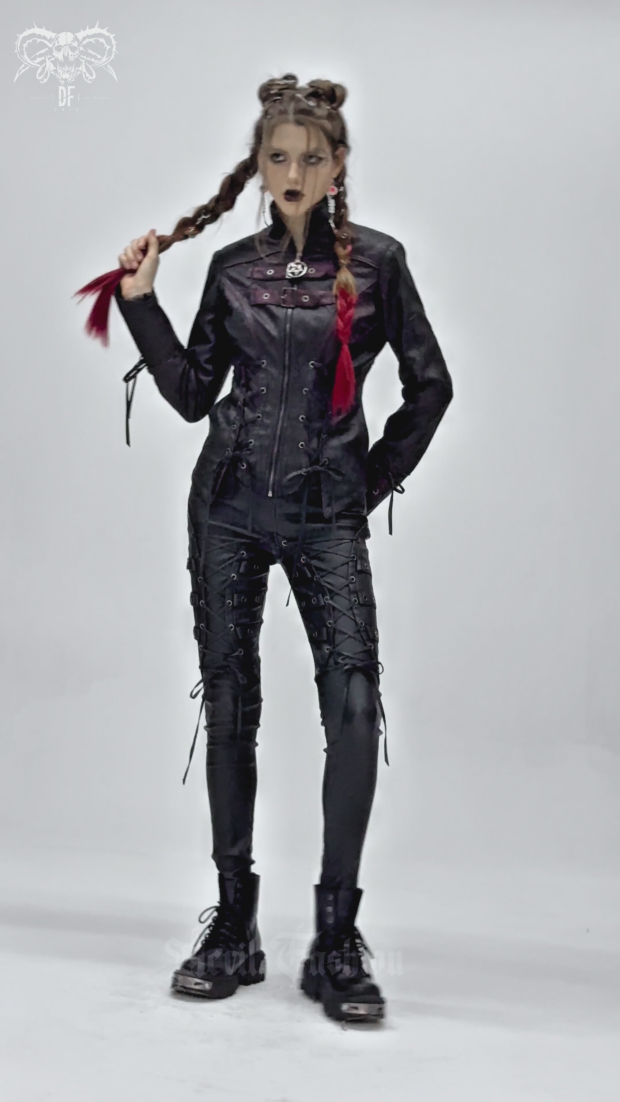 Model showcasing a gothic black faux leather jacket with buckles and lace-up details, exuding punk vibes.
