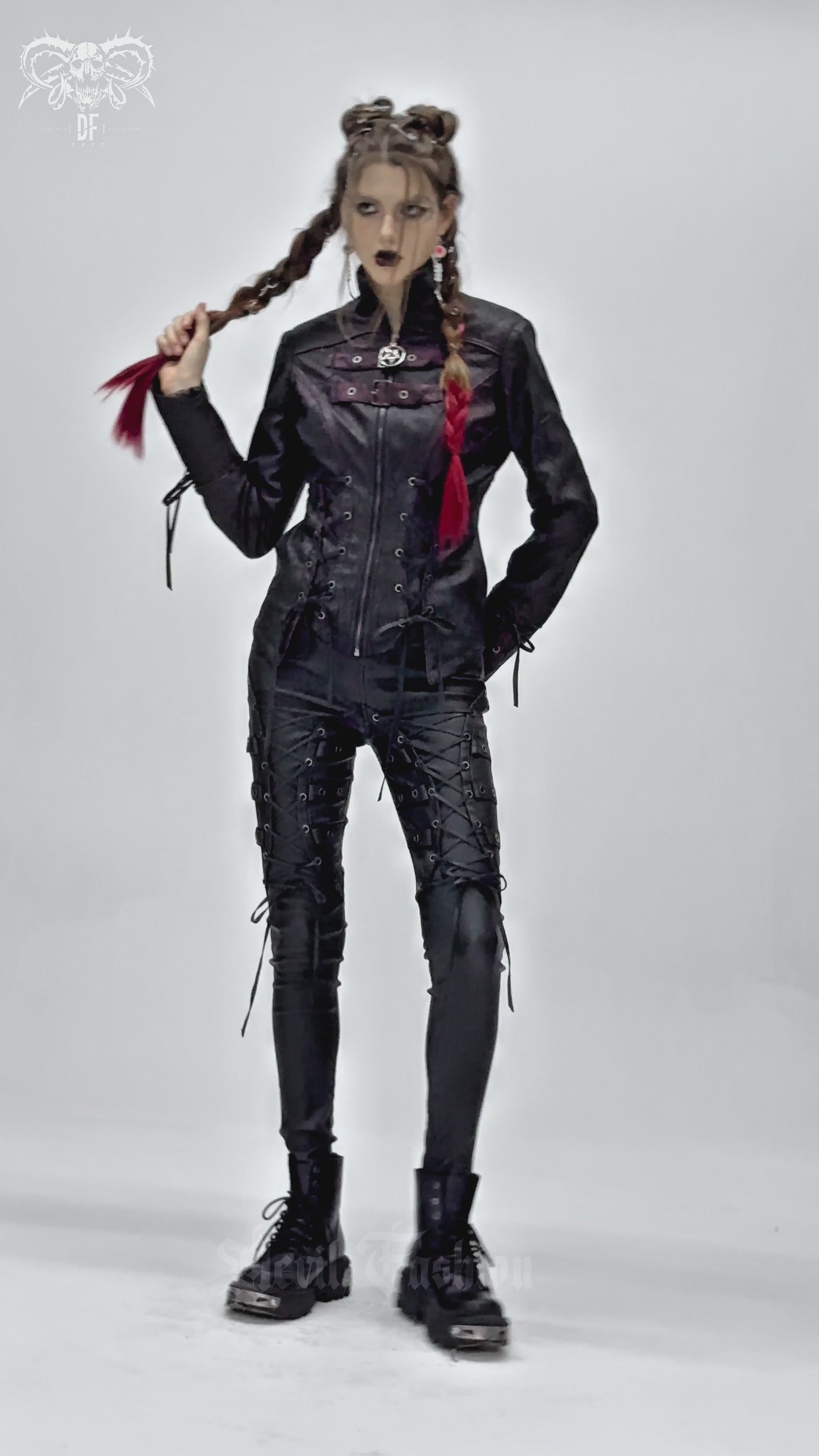 Model showcasing a gothic black faux leather jacket with buckles and lace-up details, exuding punk vibes.