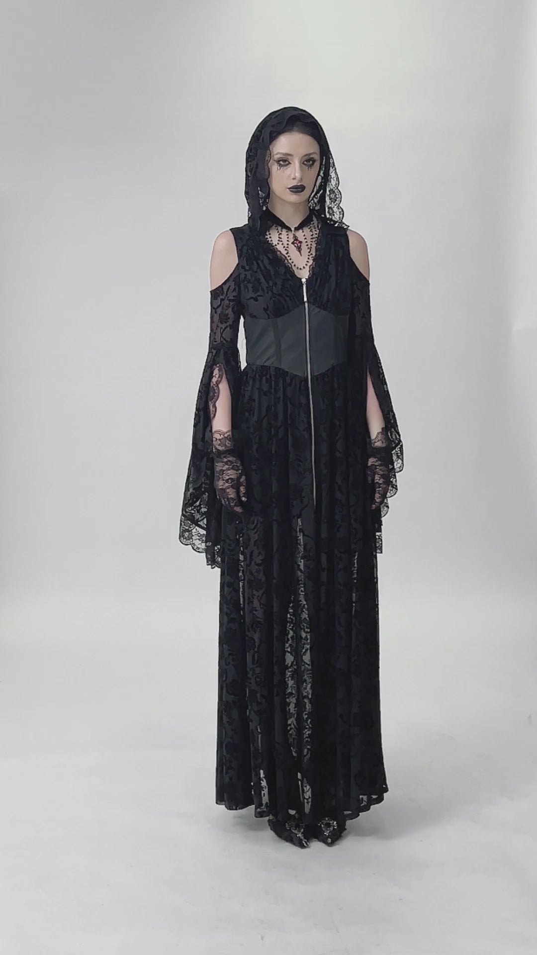 Gothic Lace Hooded Cold Shoulder Maxi Dress With Zip Closure worn by a model, showcasing dramatic lace and sheer floral details.