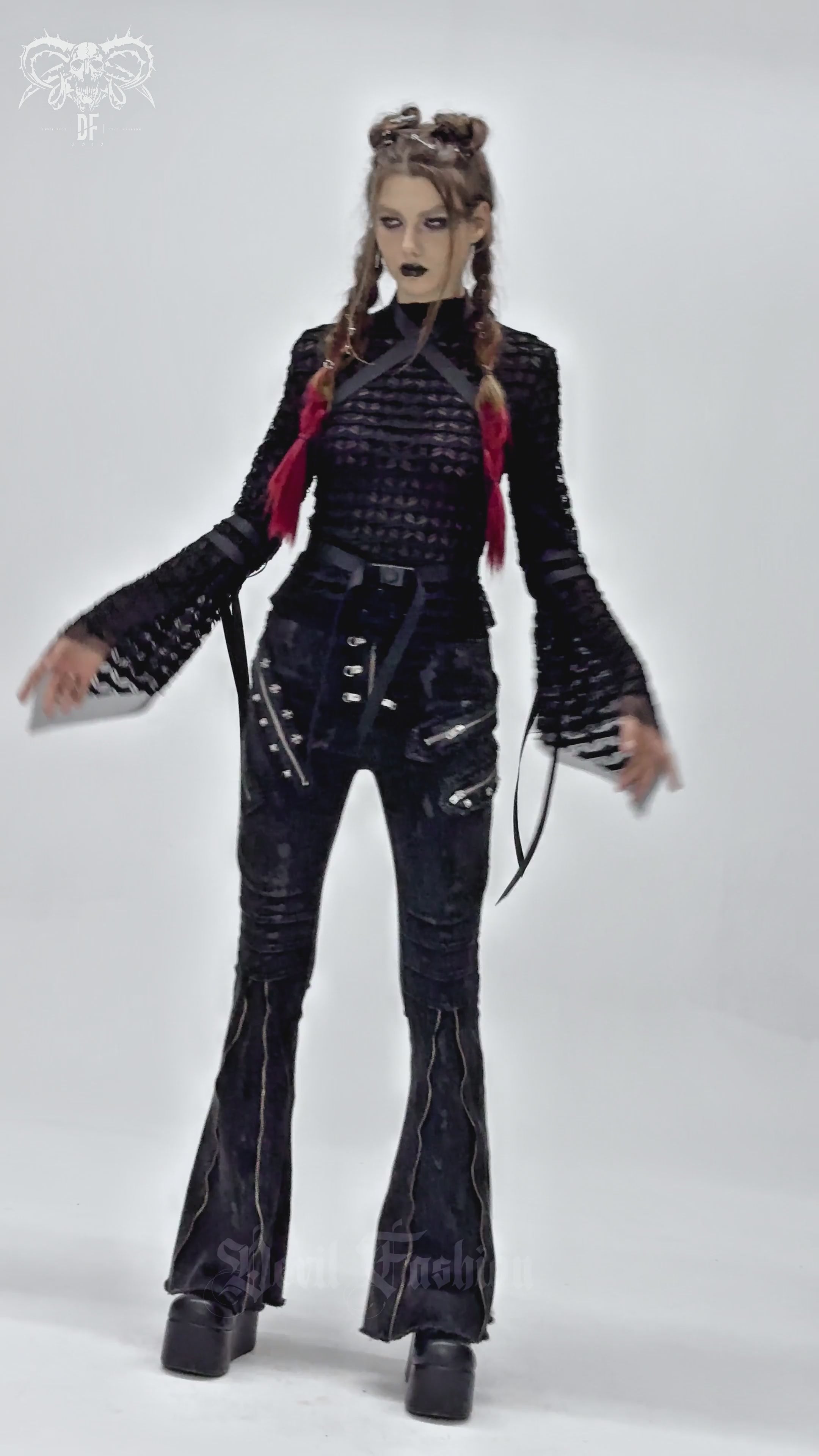 Gothic lace sheer top with straps and flared sleeves styled with black flared trousers and platform boots.