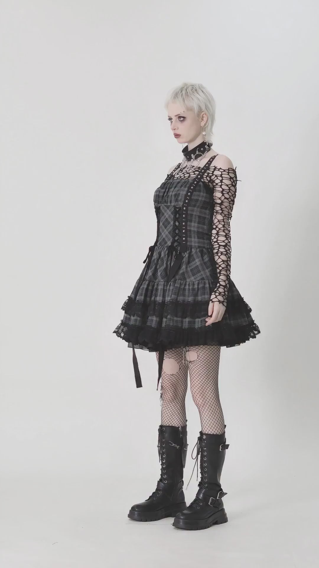 Gothic plaid mini dress features lace trim, harness straps, and ruffled skirt for punk Lolita style.