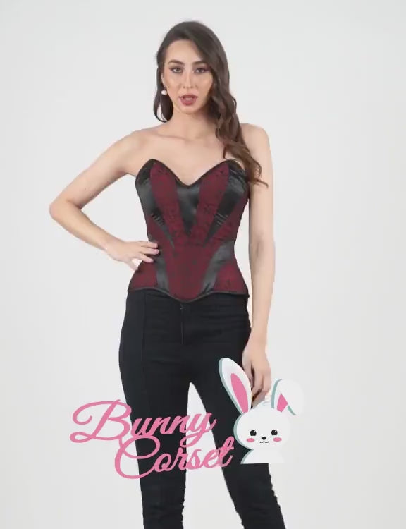 Model showcasing a sexy black and red overbust corset with sweetheart neckline, paired with stylish jeans.