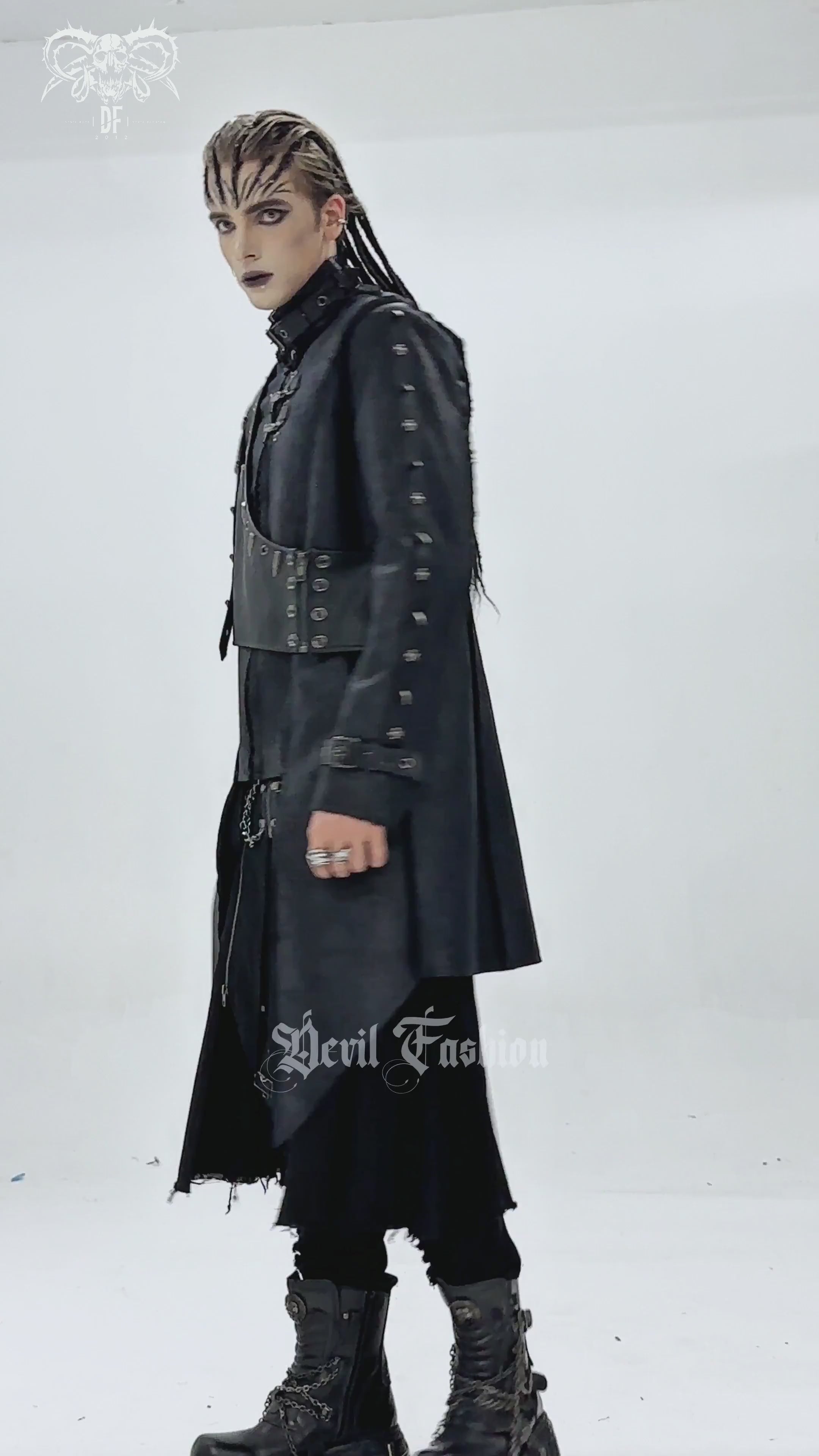 Gothic Military Long Coat with Spiked Shoulders and Straps modeled by a person showcasing its dramatic cut and edgy details.