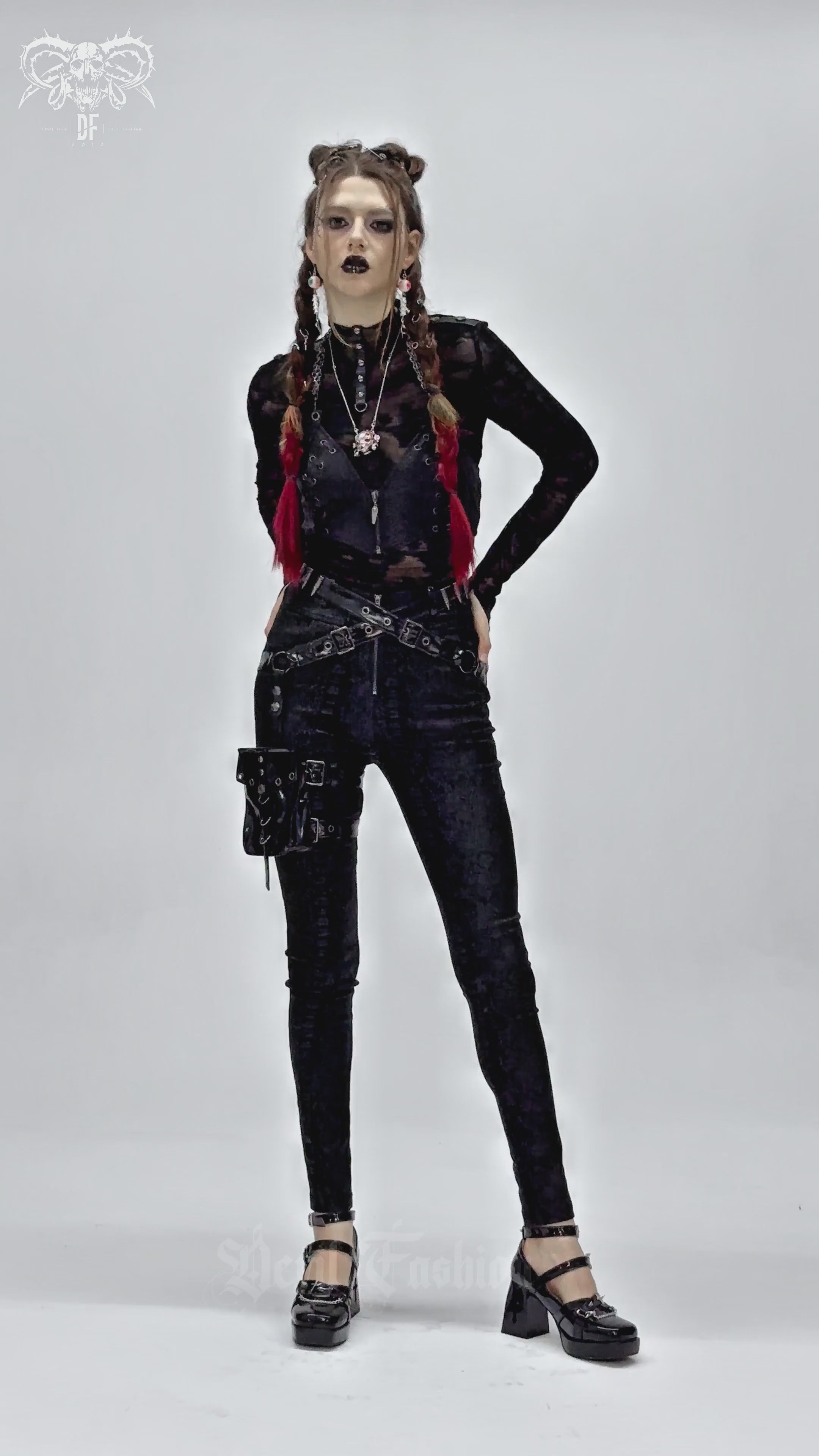 Model wearing bold skinny pants with straps and a detachable pouch, showcasing edgy streetwear style and dark fashion.