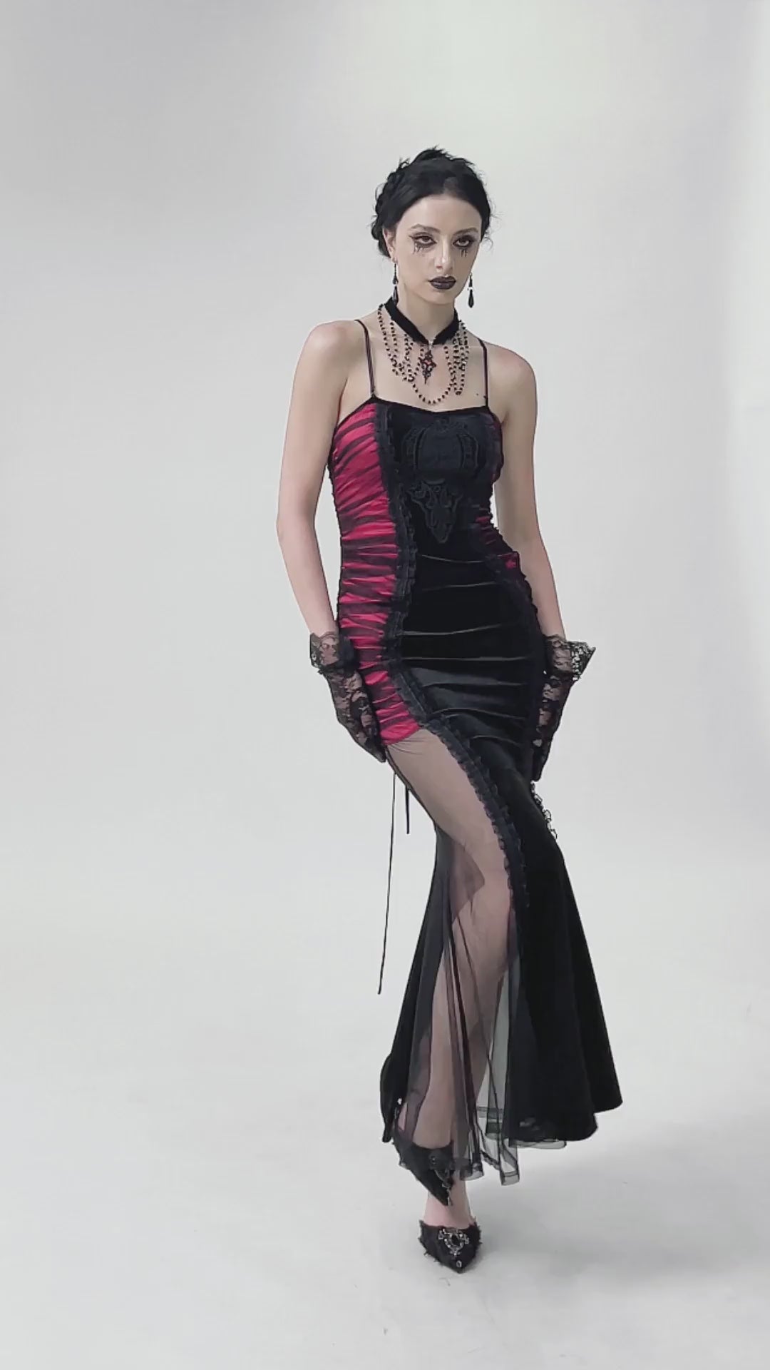Black and red gothic lace-up maxi dress with sheer sides, creating a chic and edgy look.