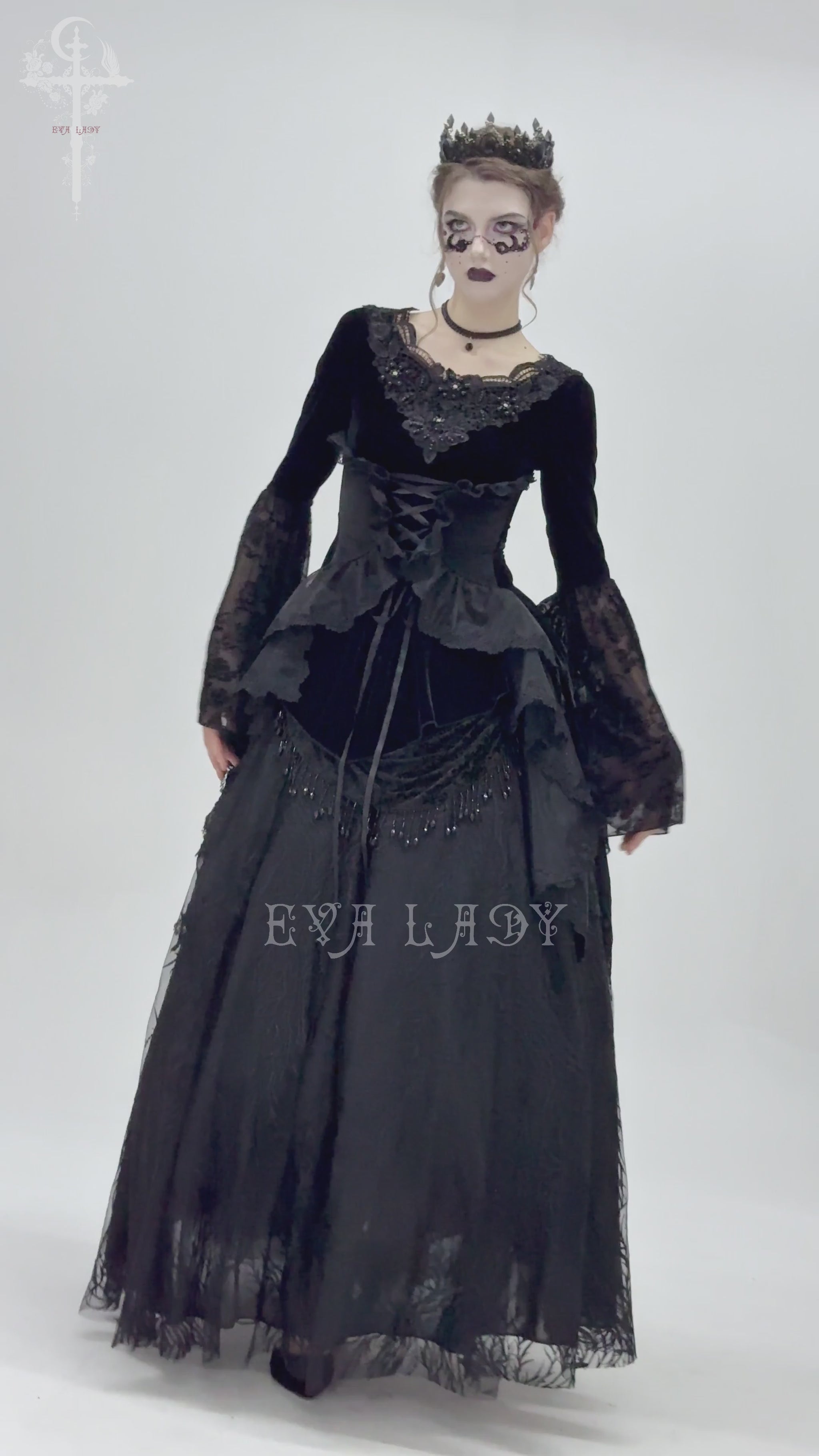 Gothic model in elegant black velvet lace skirt with beaded drapes, showcasing Victorian-inspired style and dark romance.