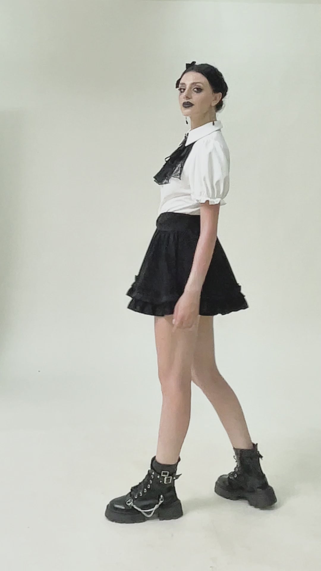 Gothic white blouse with detachable lace jabot, paired with a black skirt and combat boots for an edgy look.