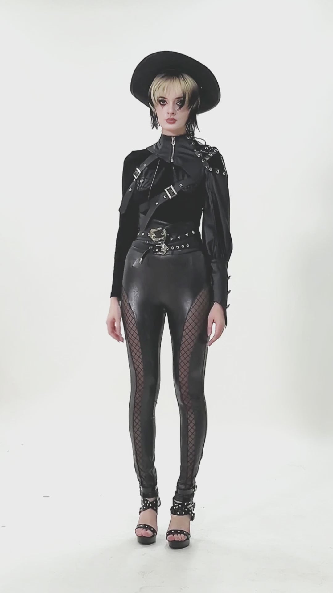 Asymmetric Punk Leather Shoulder Cape with Strap Detailing worn with edgy black outfit and hat for a bold look.