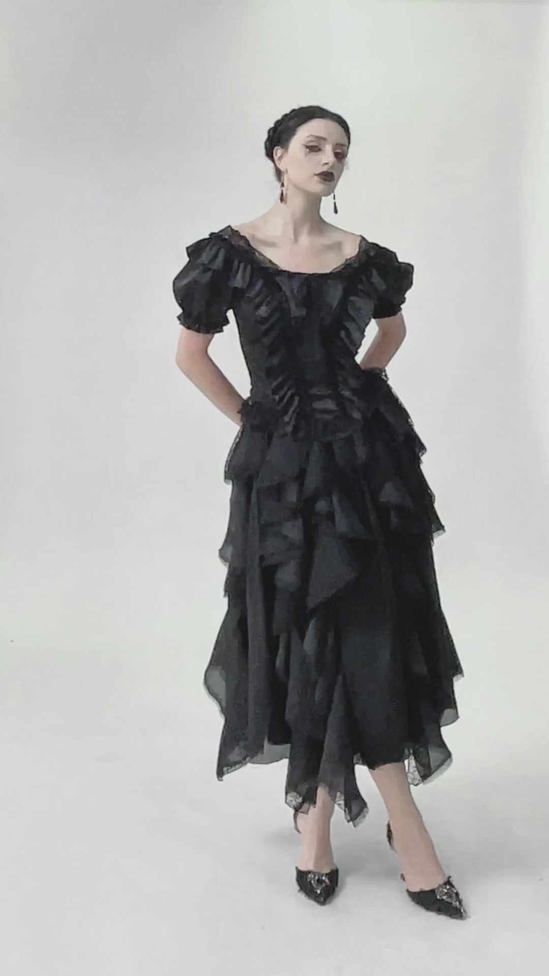 Elegant black satin top with lace ruffles and ribbon details, showcasing a dramatic Victorian-inspired look.
