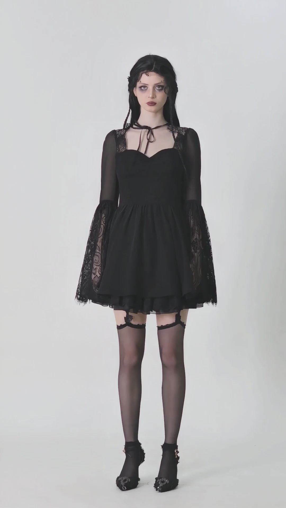 Gothic black lace bell-sleeved dress with corset back, sheer mesh upper, and romantic tie neck detail.