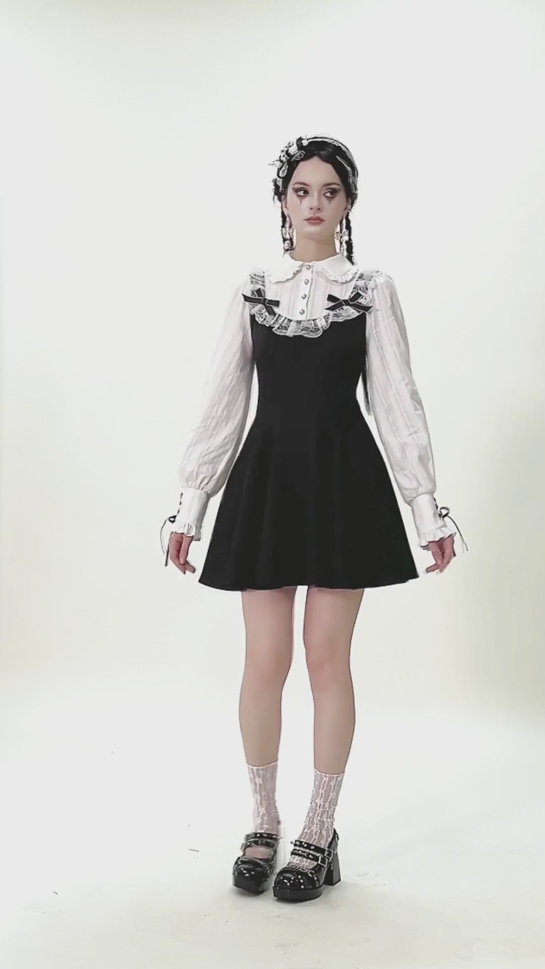 Unique Black and White Dress with Lace Collar and Bows worn by model, showcasing gothic style with ruffles and puff sleeves.