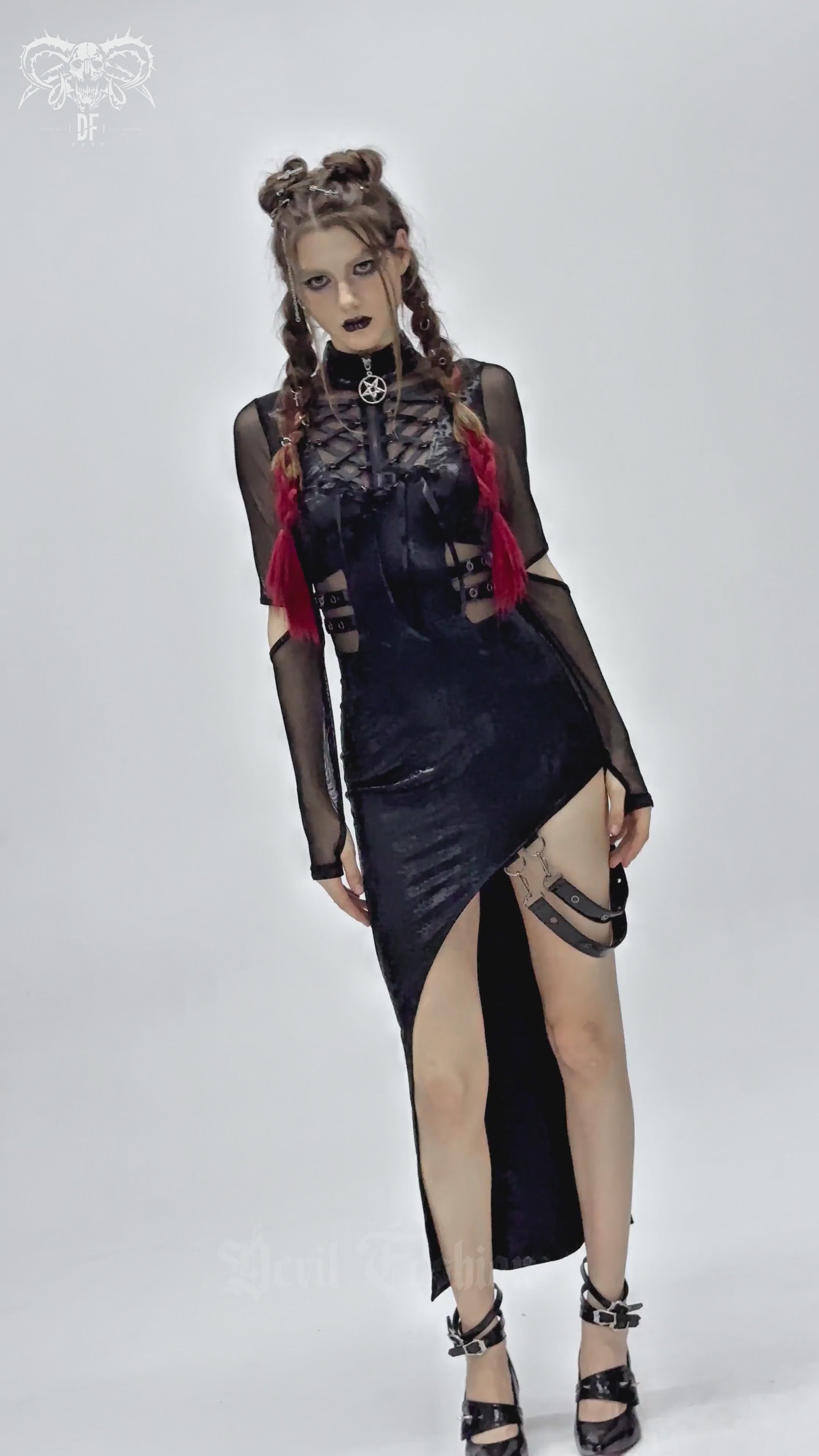 Model showcasing a gothic mesh sleeved asymmetrical dress with buckles, lace-up detail, and high slit for a bold look.