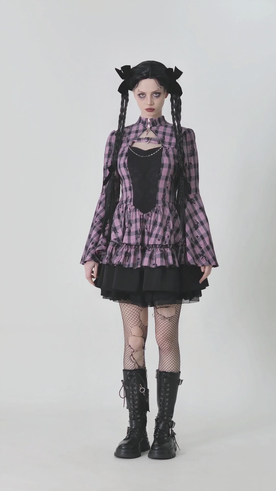 Gothic plaid dress with bell sleeves, lace details, and fishnet stockings, showcasing dark elegance and edgy style.