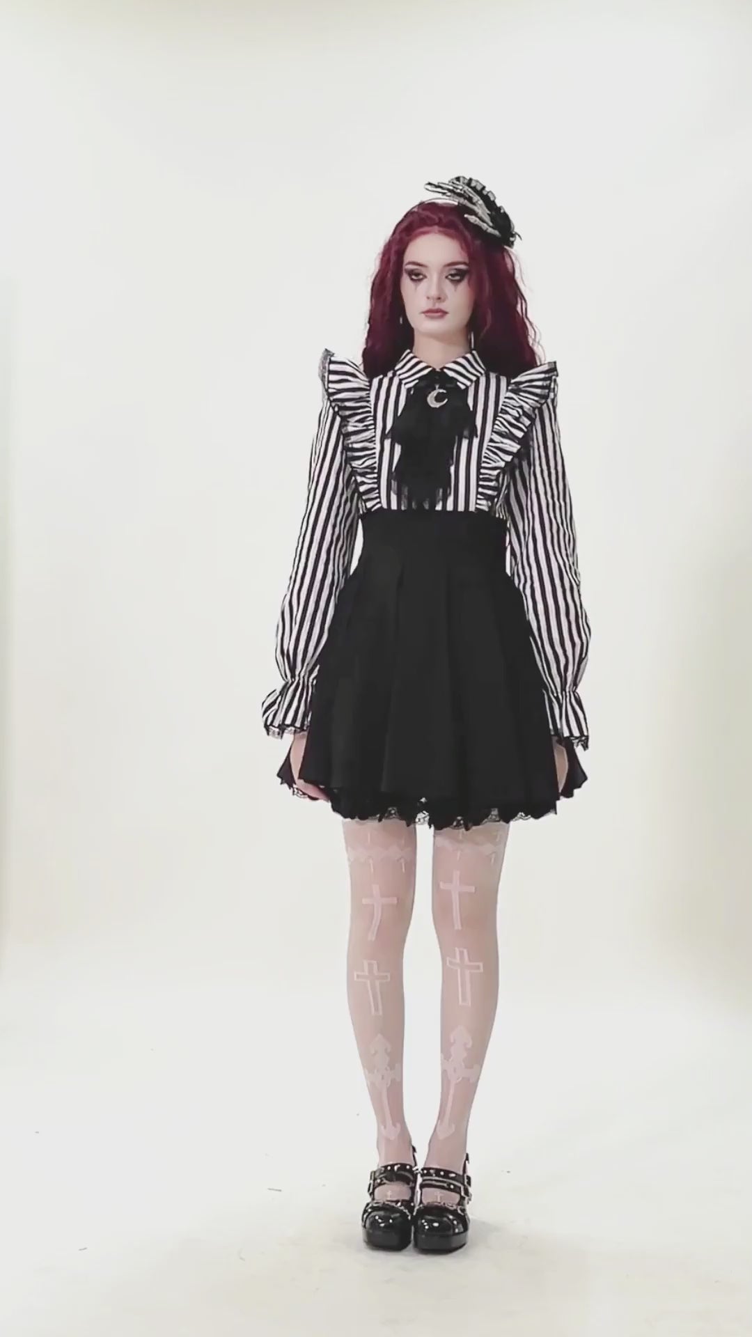 Elegant Striped Dress with Ruffle Sleeves and Moon Detail worn by a model showcasing gothic fashion style.