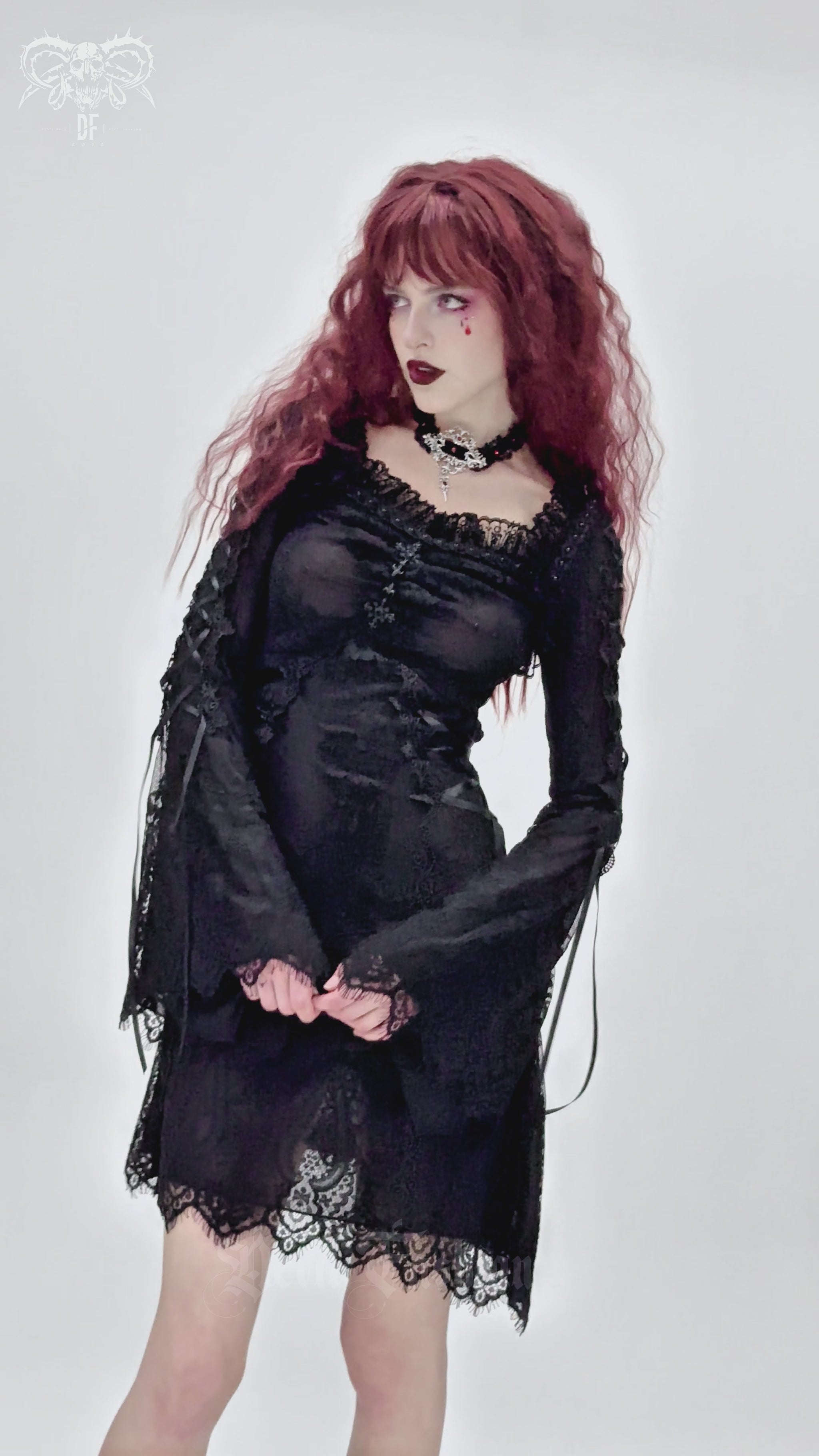 Elegant gothic black lace mini dress with flared sleeves, showcasing romantic dark style and intricate lace details.