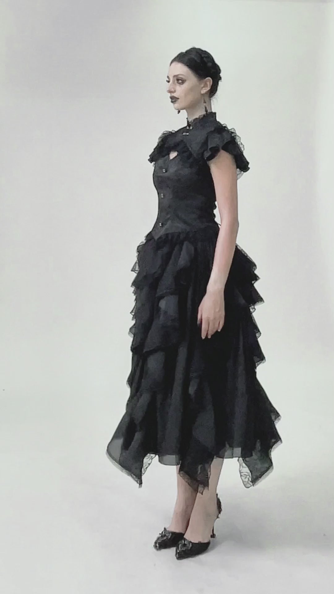 Model showcasing a black gothic jacquard top with puff sleeves, frills, and lace detailing against a neutral background.