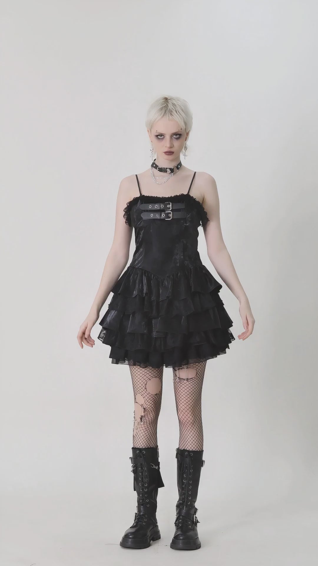 Gothic-inspired mini dress featuring layered ruffles, PU leather bodice, and punk accessories for alternative fashion lovers.