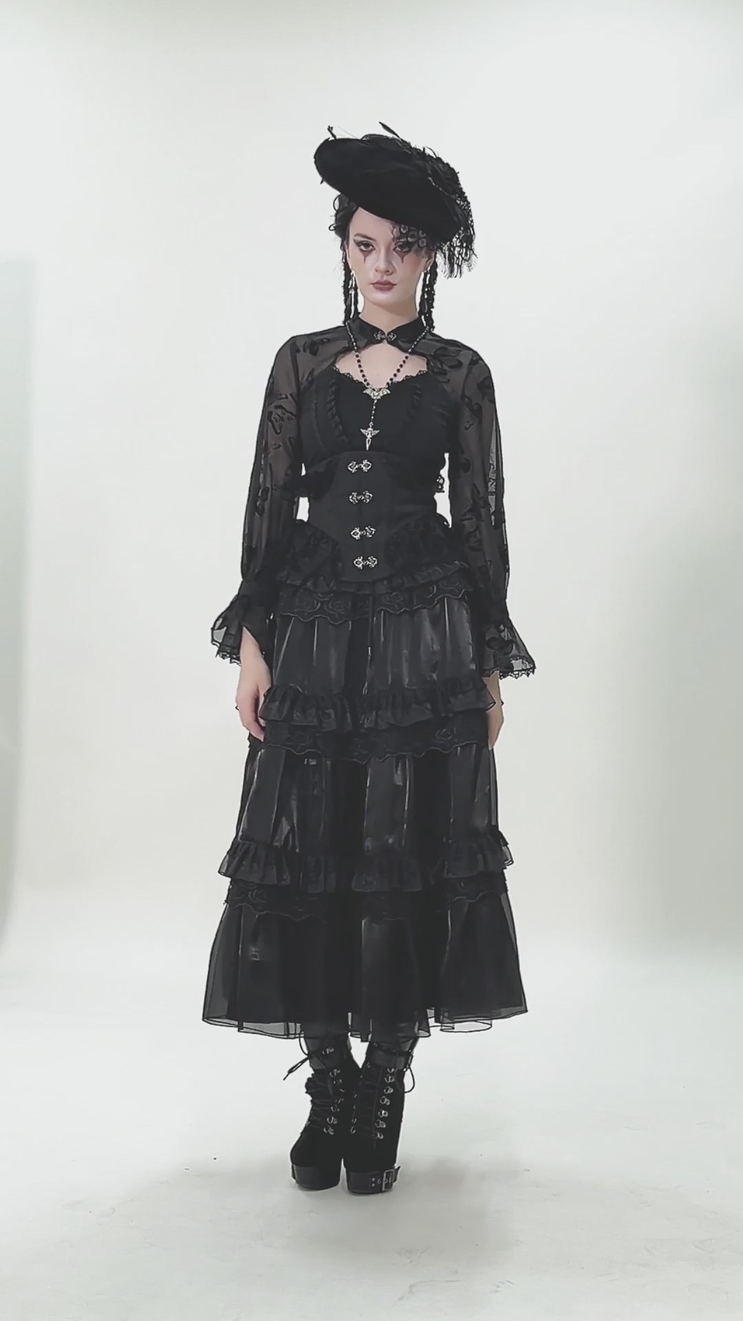 Model wearing a Lace-Trimmed Black Gothic Corset with Front Clasp Closure paired with a black layered skirt.