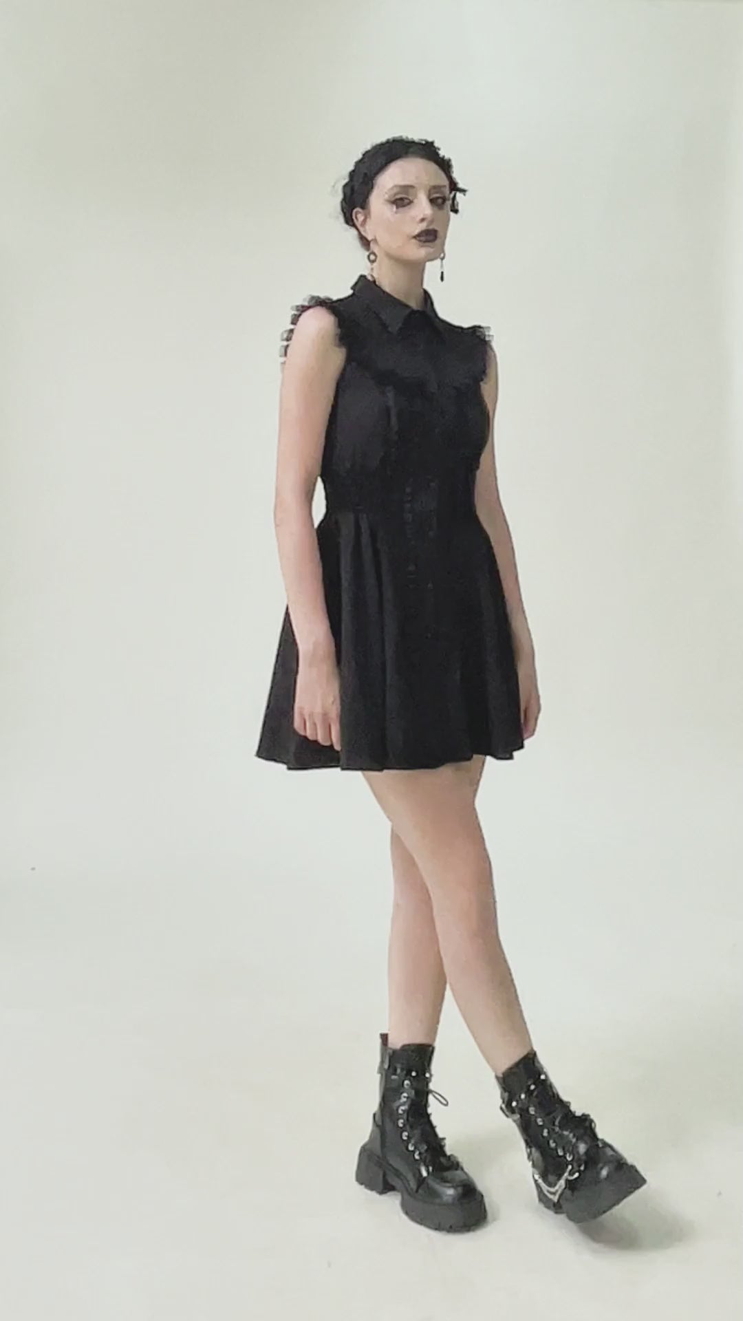 Black Gothic Ruffle Front Dress with Buttoned Detailing worn by a model, showcasing its edgy and romantic style.