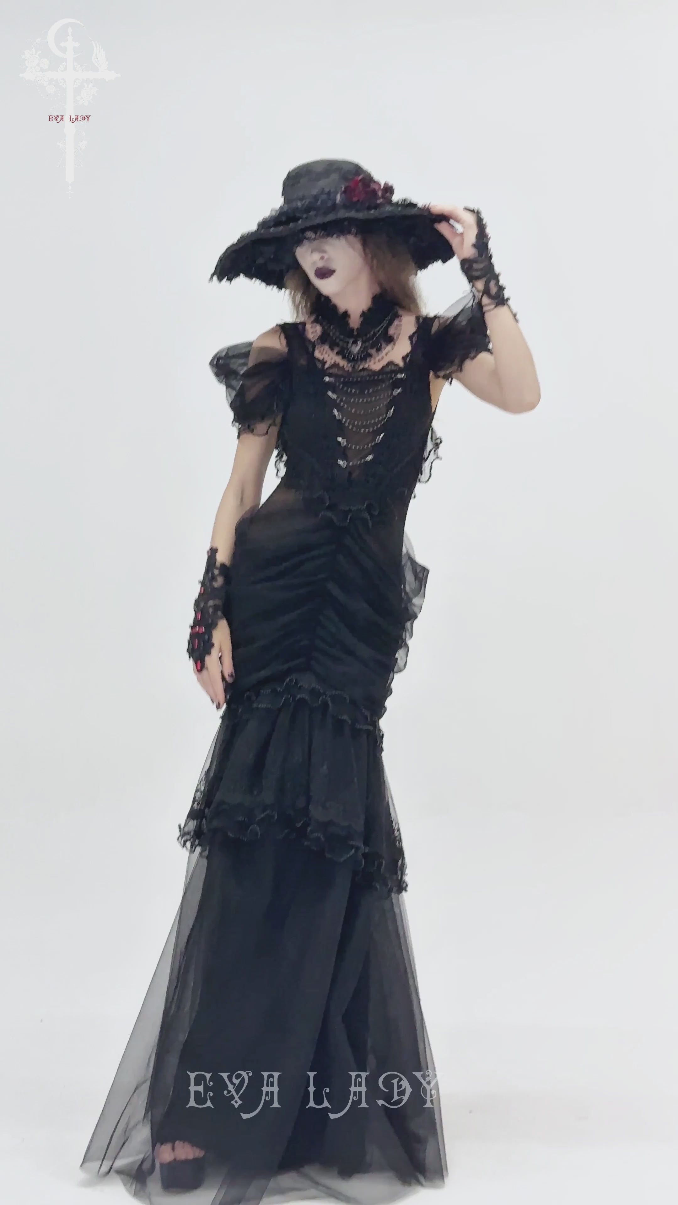 Black Gothic Lace-Up Dress with Ruffled Tulle and Roses modeled by a woman in a dramatic pose.