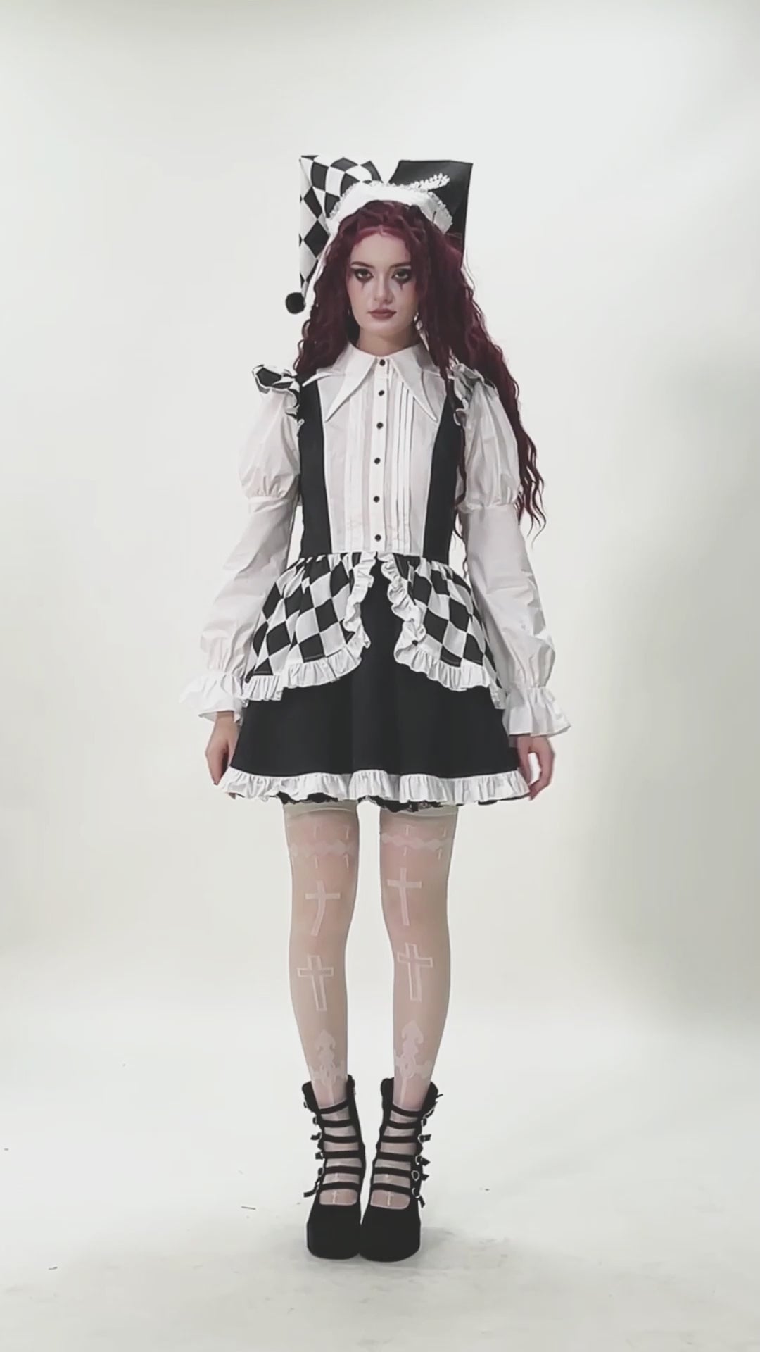 Model showcasing the Harlequin Black and White Gothic Ruffle Mini Dress with checkered patterns and stylish accessories.