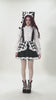 Model showcasing the Harlequin Black and White Gothic Ruffle Mini Dress with checkered patterns and stylish accessories.